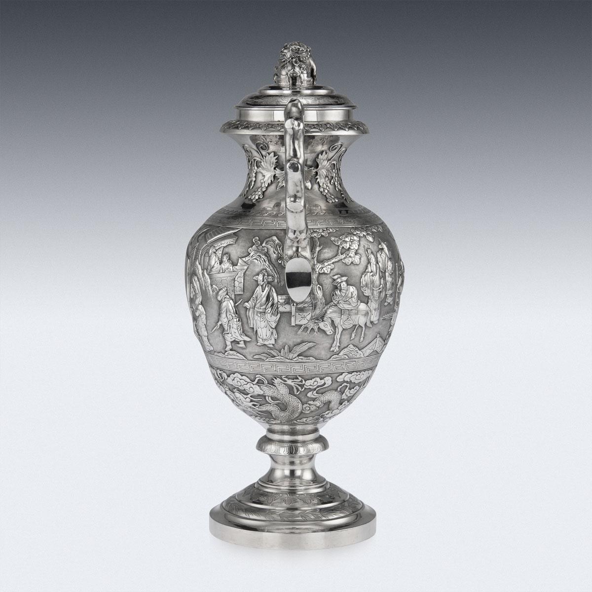 Antique 19th century Chinese export solid silver presentation cup and cover, of traditional urn shape, the body is embossed with beautiful scenes in relief depicting Chinese nobility amongst village landscape, between Greek key borders and above a