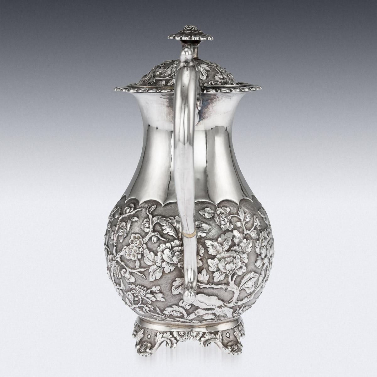 Antique 19th Century Chinese export solid silver coffee pot, pear-shaped, the body is beautifully decorated in relief with chrysanthemums and cherry blossom on matted ground, very crisp and detailed, mounted with an elegant leaf-capped handle and