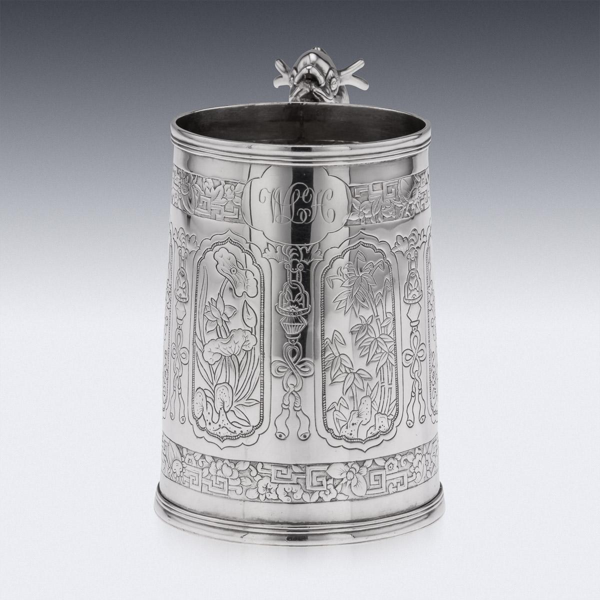 19th Century Chinese silver mug, of traditional tapered shape and size, the body decorated with six lozenge shaped panels, engraved inside with various scenes, such as bamboo, blossoming cherry trees, water lillies, the front centered with a