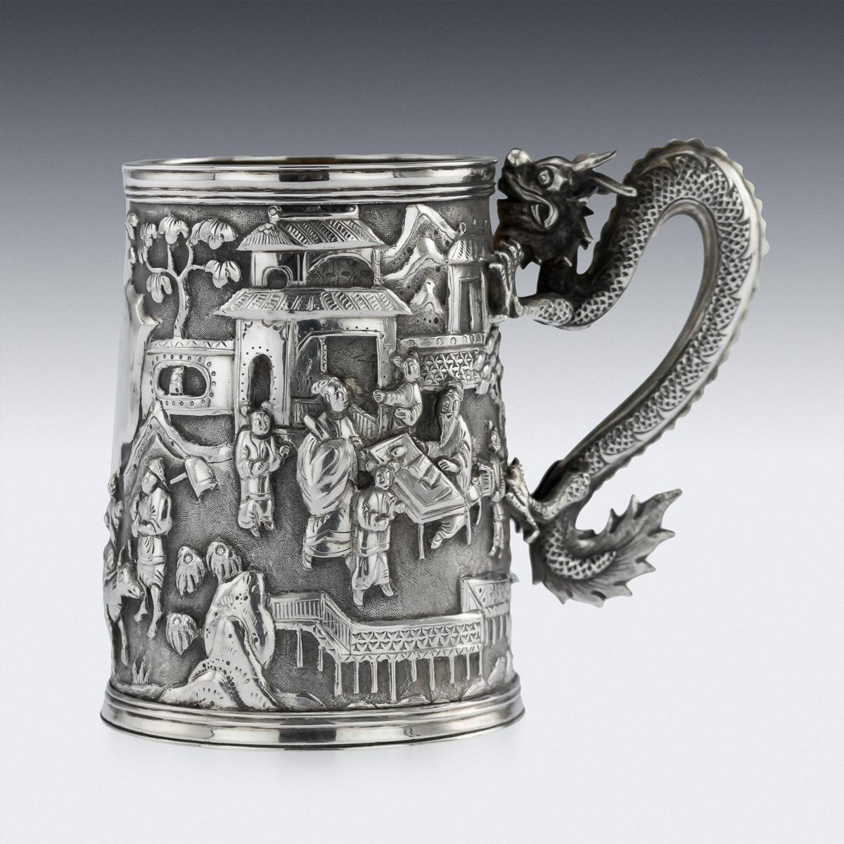 Antique late 19th century Chinese export solid silver mug, of tapering form, the sides are beautifully decorated in relief with a scene of a Chinese village, very crisp and detailed, centering a vacant shaped cartouche. The handle is beautifully