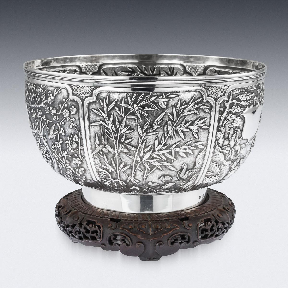 Antique late-19th century Chinese export solid silver fruit bowl on stand, of exceptionally fine quality, intricately chased and embossed depicting a compendium of various designs and themes, two shaped panels depicting densely populated scenes,