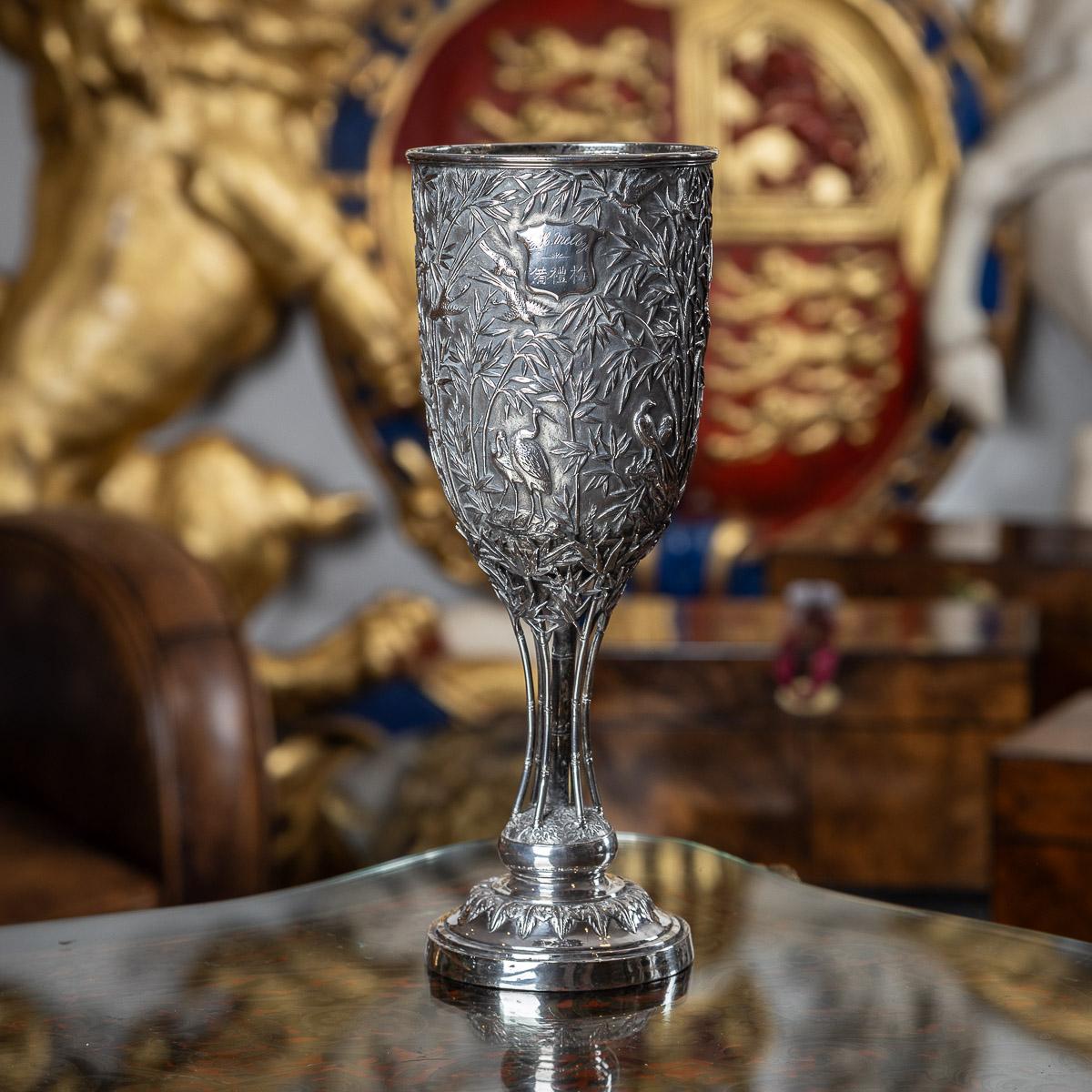 Antique 19th Century Chinese export solid silver goblet, a testament to its impressive size and exceptional craftsmanship. The goblet, a marvel of fine quality, boasts a single-walled vessel that is fully adorned with intricate chasing and embossing