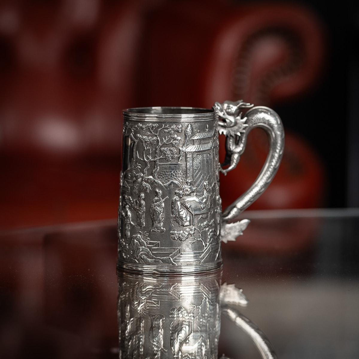 Antique 19th Century Chinese export solid silver ornamental mug, the body is embossed with beautiful scenes in relief depicting Chinese nobility amongst city landscape, double walled, the front centering with an vacant round shaped cartouche, the