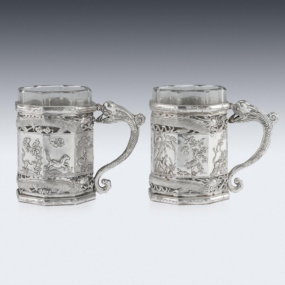 Antique 19th Century Chinese export solid silver tea glass holders, octagonal shaped, the sides are beautifully decorated in relief with various scenes depicting animals and birds in landscape, very crisp and detailed, the front engraved with