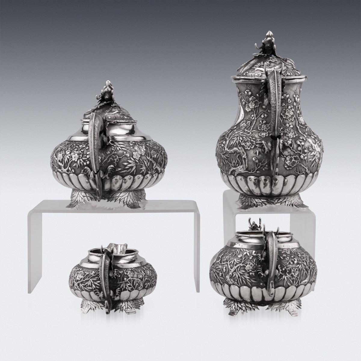 Antique 19th Century Chinese Export solid silver four piece tea set, comprising of a coffee pot, teapot, sugar bowl, milk jug, each bulbous shaped body beautifully chased with cherry blossom amongst bamboo on a matted surface, each fluted base