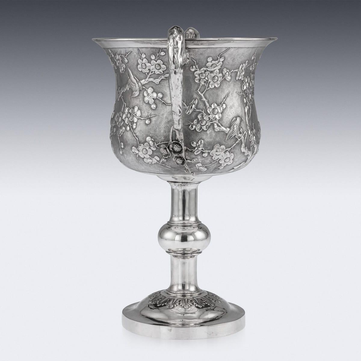 Antique late-19th Century Chinese export solid silver trophy cup, impressive and exceptionally fine quality, decorated with repoussé prunus and perched birds against a hand chased matted ground, cup resting on an elegant shaped stem and domed foot,