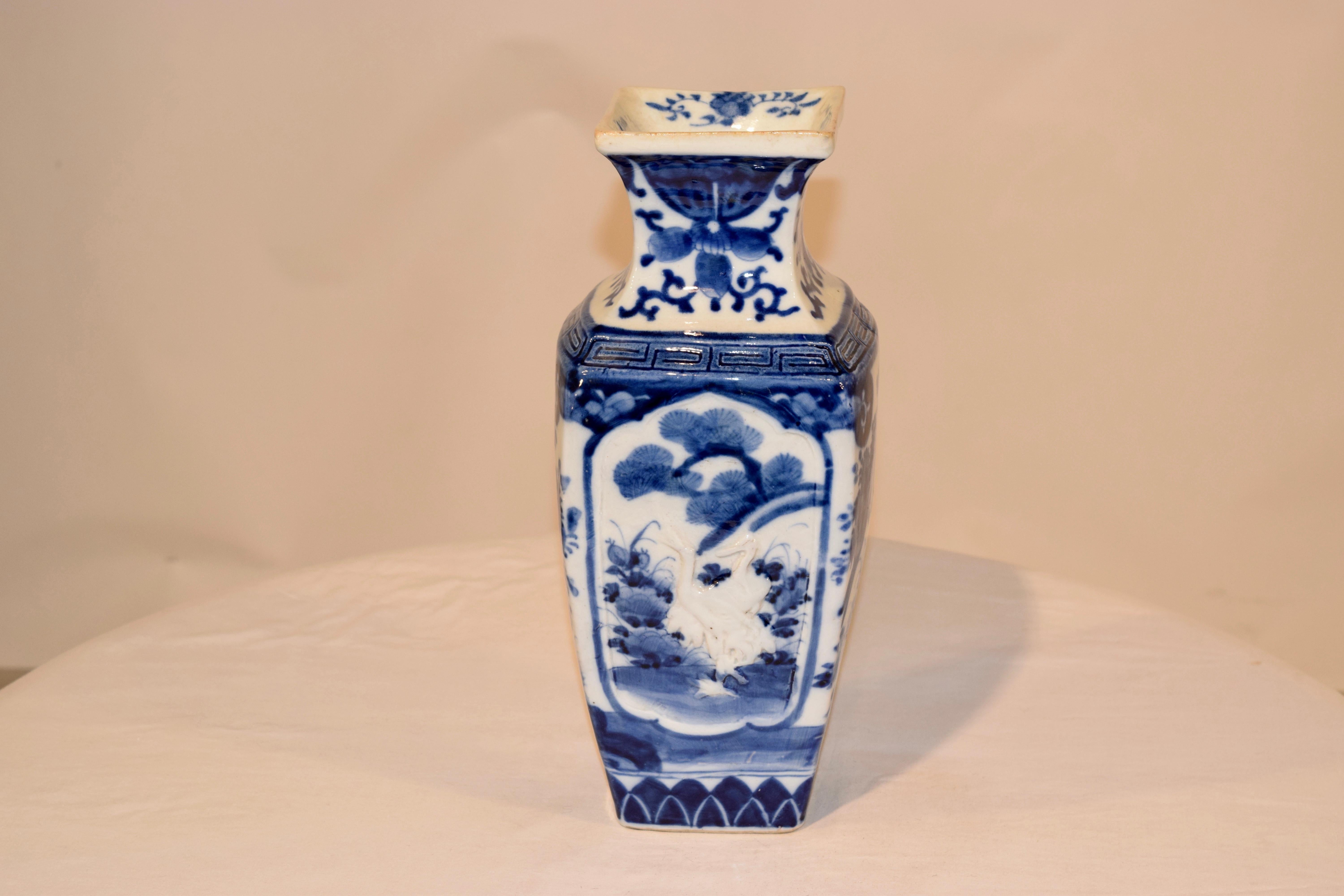 19th century Chinese export vase in vibrant hues of blue with medallions on two sides framing garden scenes and two relieved white cranes. On the opposite sides are lovely hand painted scenes with birds perching on branches, surrounded by florals.