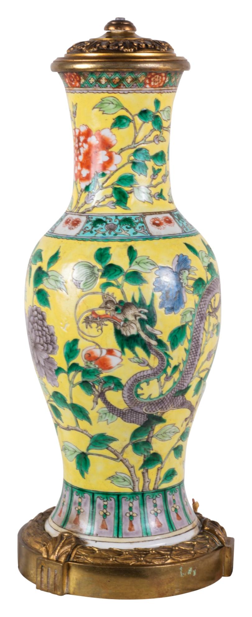 Llamativo jarrón / lámpara chino Famille Jaune del siglo XIX. Tiene un maravilloso fondo amarillo con bordes de motivos clásicos, decoración floral exótica que rodea a un dragón mítico. Montada sobre una base clásica de ormolina dorada.