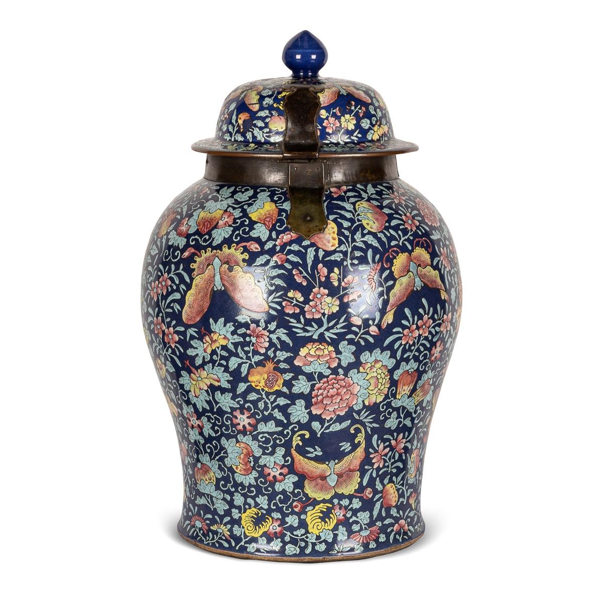 Antique 19th Century pair of Chinese famille noir ginger jars featuring a black background with an abundance of verte colour foliage and brightly coloured butterflies and flowers. Mounted with bronze collars and hinged locks on the lids. Rare colour