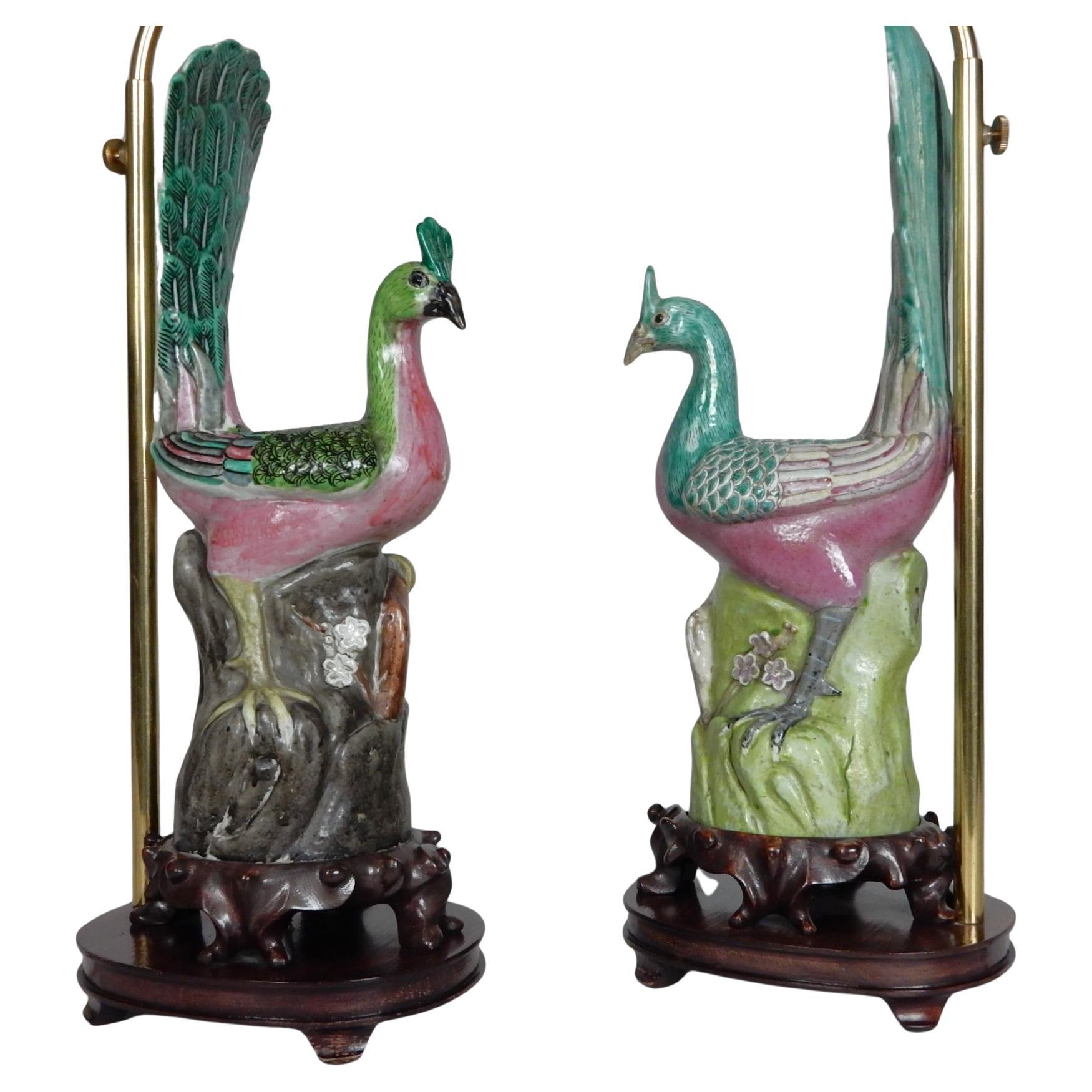 A pair of Chinese export famille rose enameled porcelain peacocks. These gorgeous birds are portrayed perched on rocky outcroppings with heads turned to one side. Painted in beautiful enamels of pink, yellow and green.
Each presented on fitted