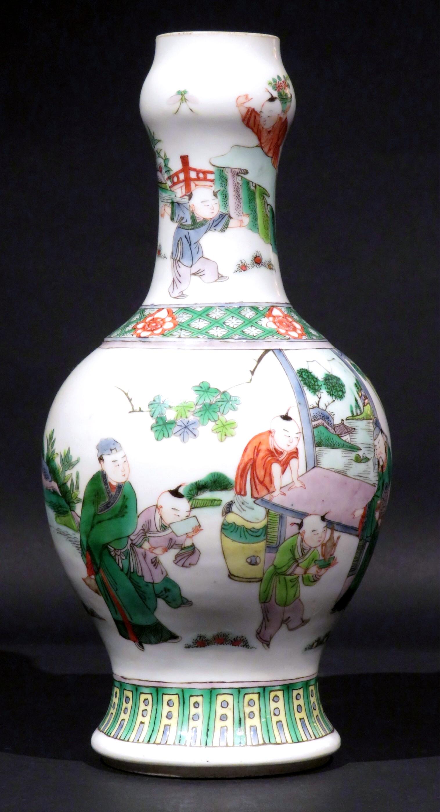The globular body decorated with hand applied enamels depicting nobles taking tea while surrounded by attendants and small children. The slender neck rising to a bulbous mouth (seemingly ground), the underside of the base showing small firing cracks