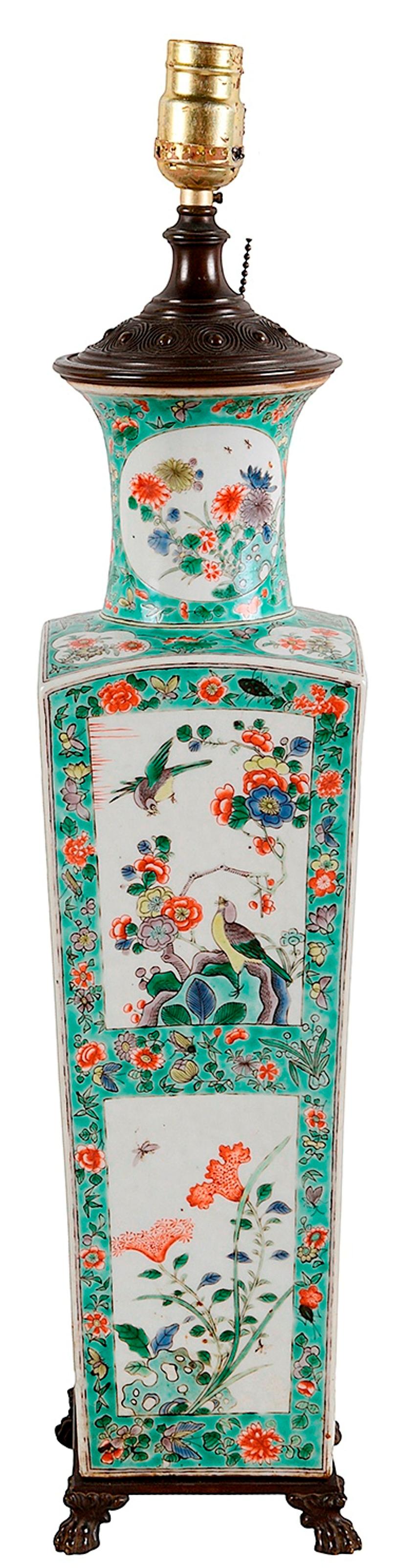 A very good quality 19th century Chinese Famille Verte vase or lamp. Having wonderful hand painted inset panels to the green ground, depicting birds, flowers and various plants. Tapering form, raised on bronze claw feet. Measures: 53cm (21