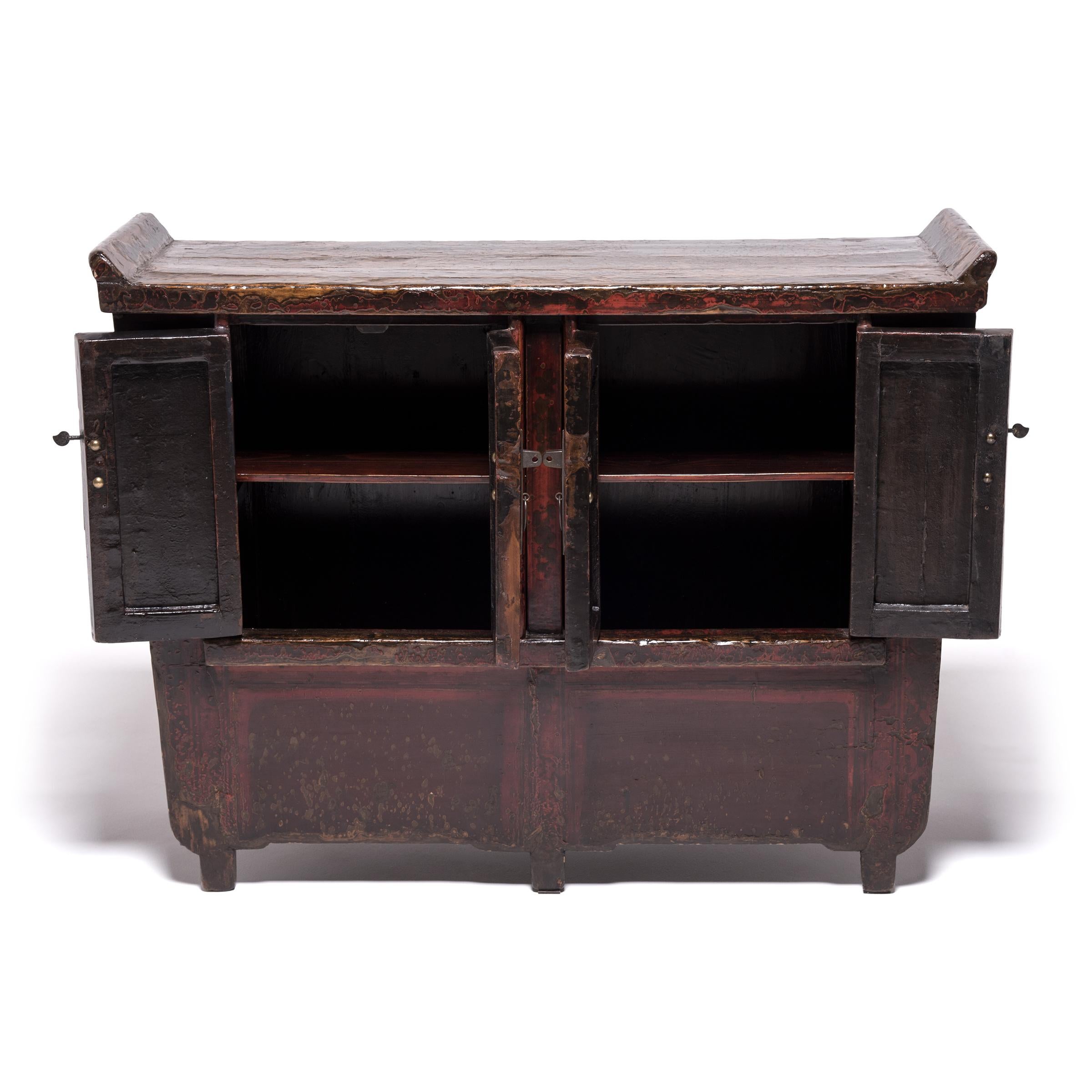 A more rustic interpretation of classic Qing-dynasty furniture, this antique chest simplifies the silhouette with pert, upturned flanges and just a hint of taper to its square frame. Once a brilliant shade of red, an emblem of joy and prosperity,