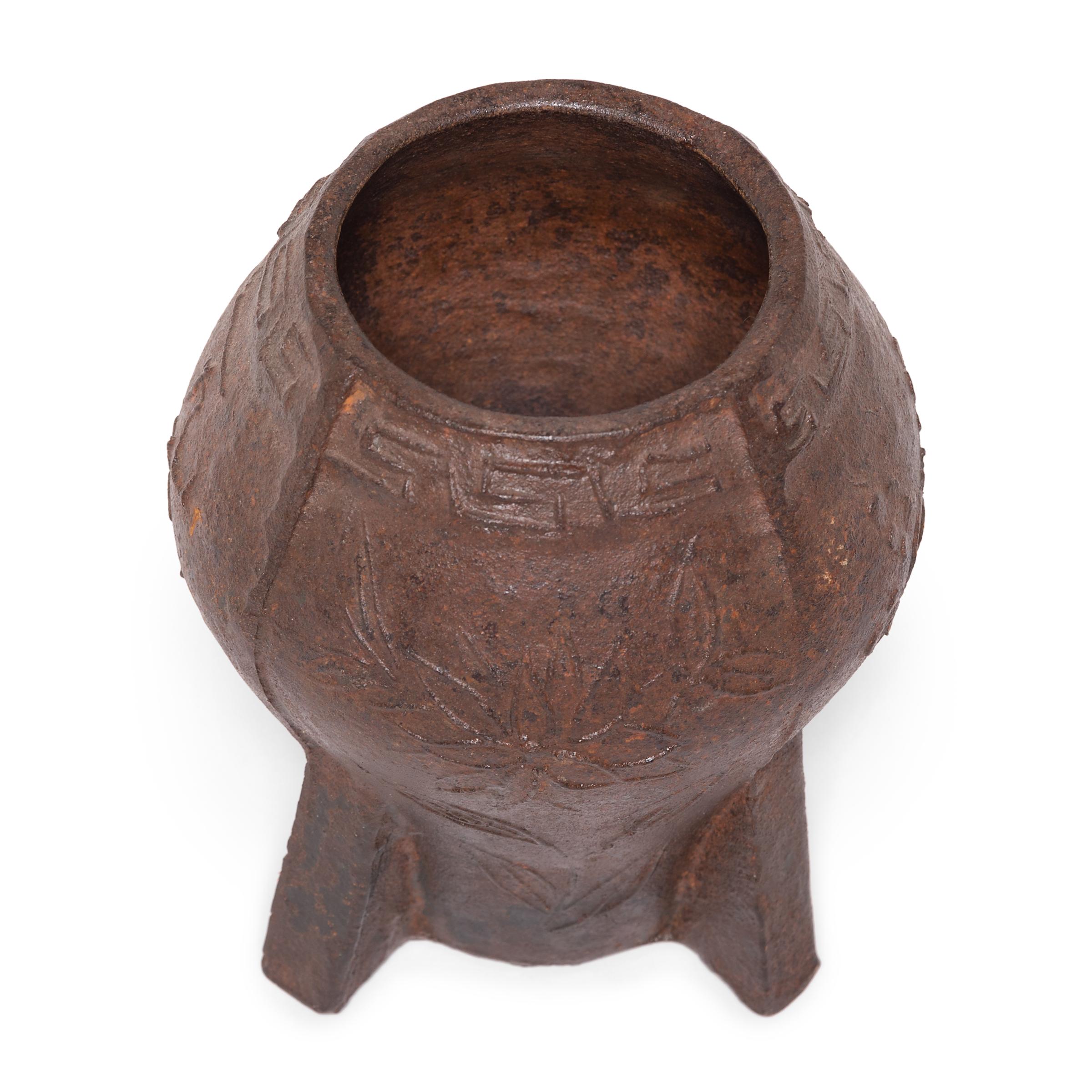 This vintage cast iron mortar and pestle from is from China's Shanxi province and is patterned in low relief with floral motifs. It was originally used in a traditional apothecary to create herbal medicine, but we love this piece as an unexpected