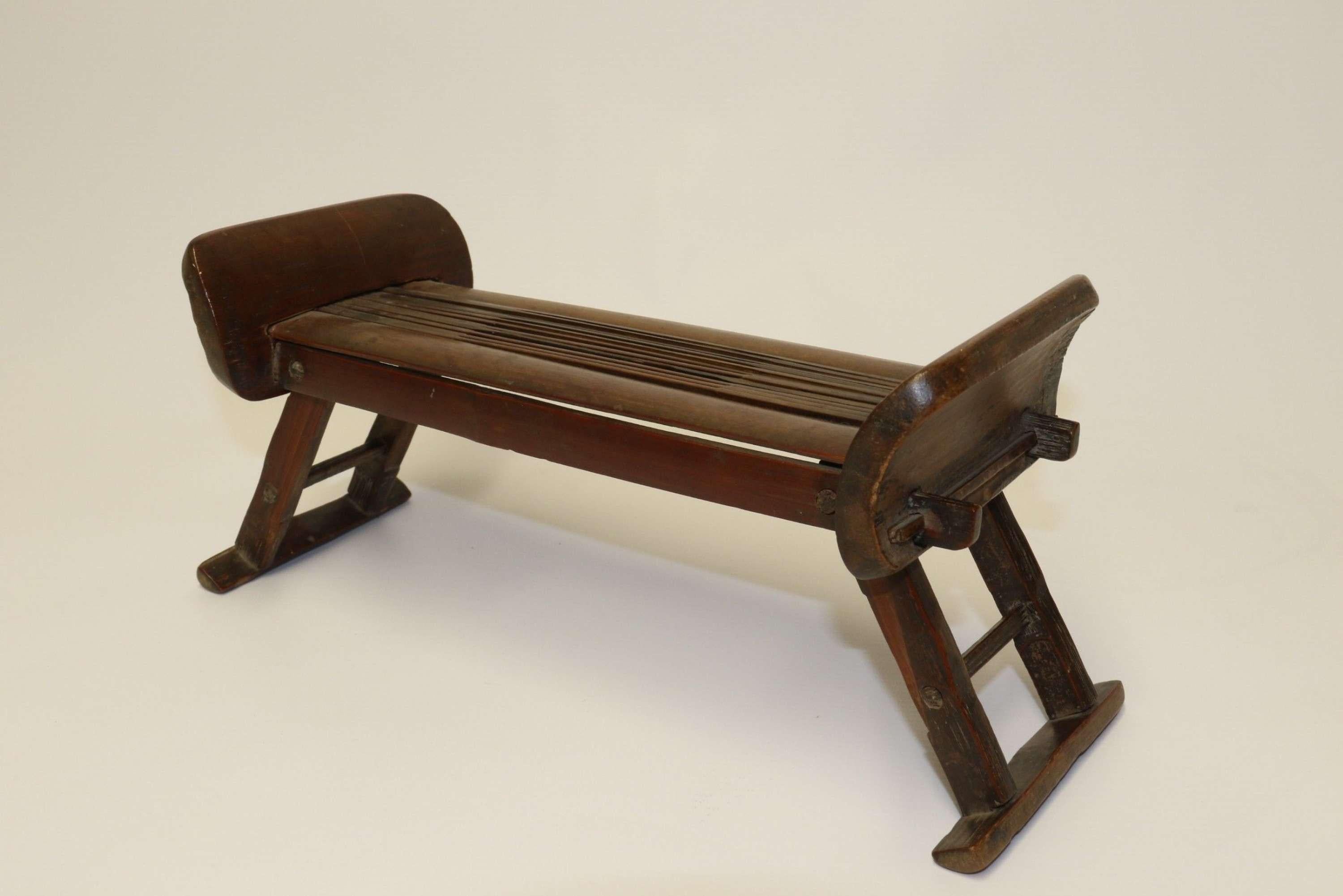 A rare 19th century Chinese folding bamboo headrest.

This ingenious rare and beautifully made piece dates to circa 1800. It is cleverly designed enabling it to fold flat for ease of transport. This is not a decorative export item but would have