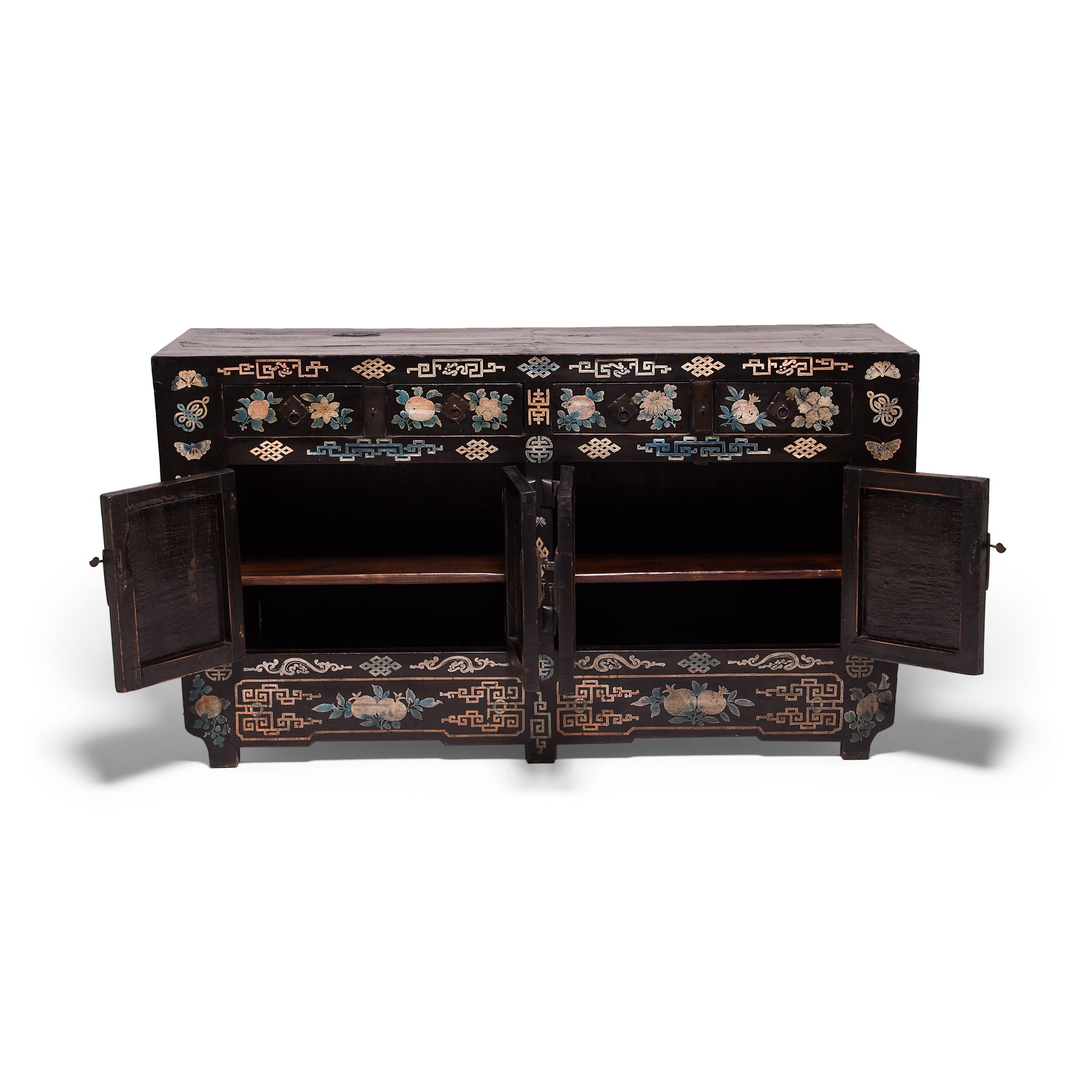 Crafted by an artisan in China's Shanxi province, this spirited 19th century coffer would have been kept in the home as a blessing of luck and good fortune. The beautifully maintained and ornate folk paintings covering the cabinet depict all things