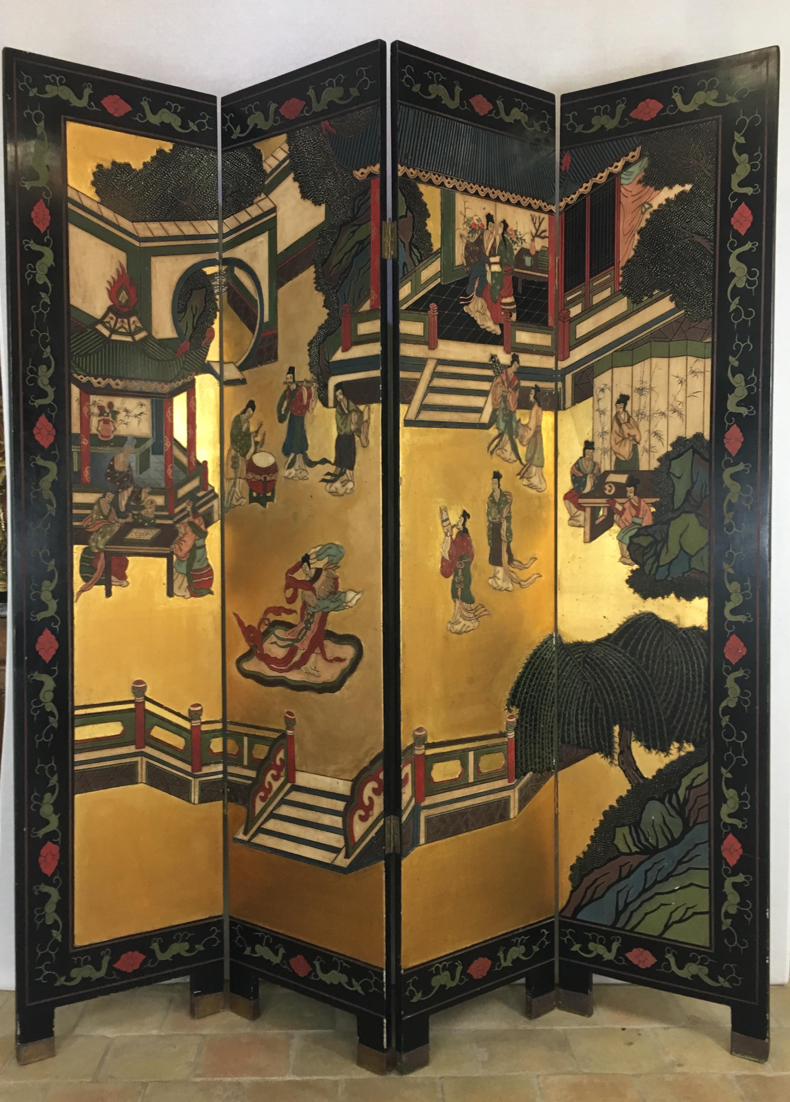 A beautifully detailed 19th century four panel, hand-carved and hand-painted dressing screen or room divider featuring social gatherings of families, musicians and scholars, around pagodas and landscaped gardens. 

This very decorative screen is