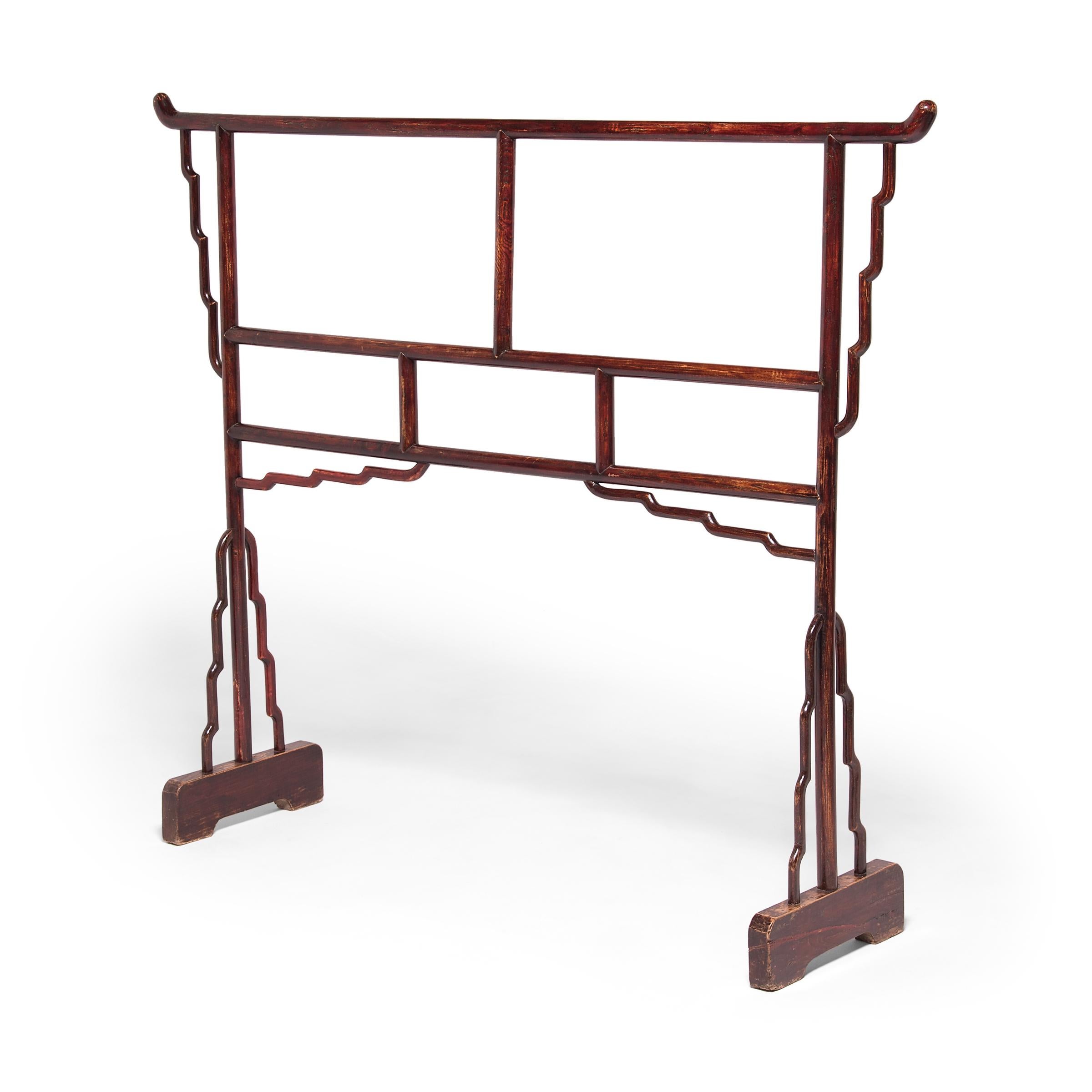 Crafted by an artisan in China's Shanxi province, this mid-19th century elmwood garment rack has a spare, linear design with large open areas to accommodate folded textiles. Since conventional Qing-dynasty homes did not contain any closets,