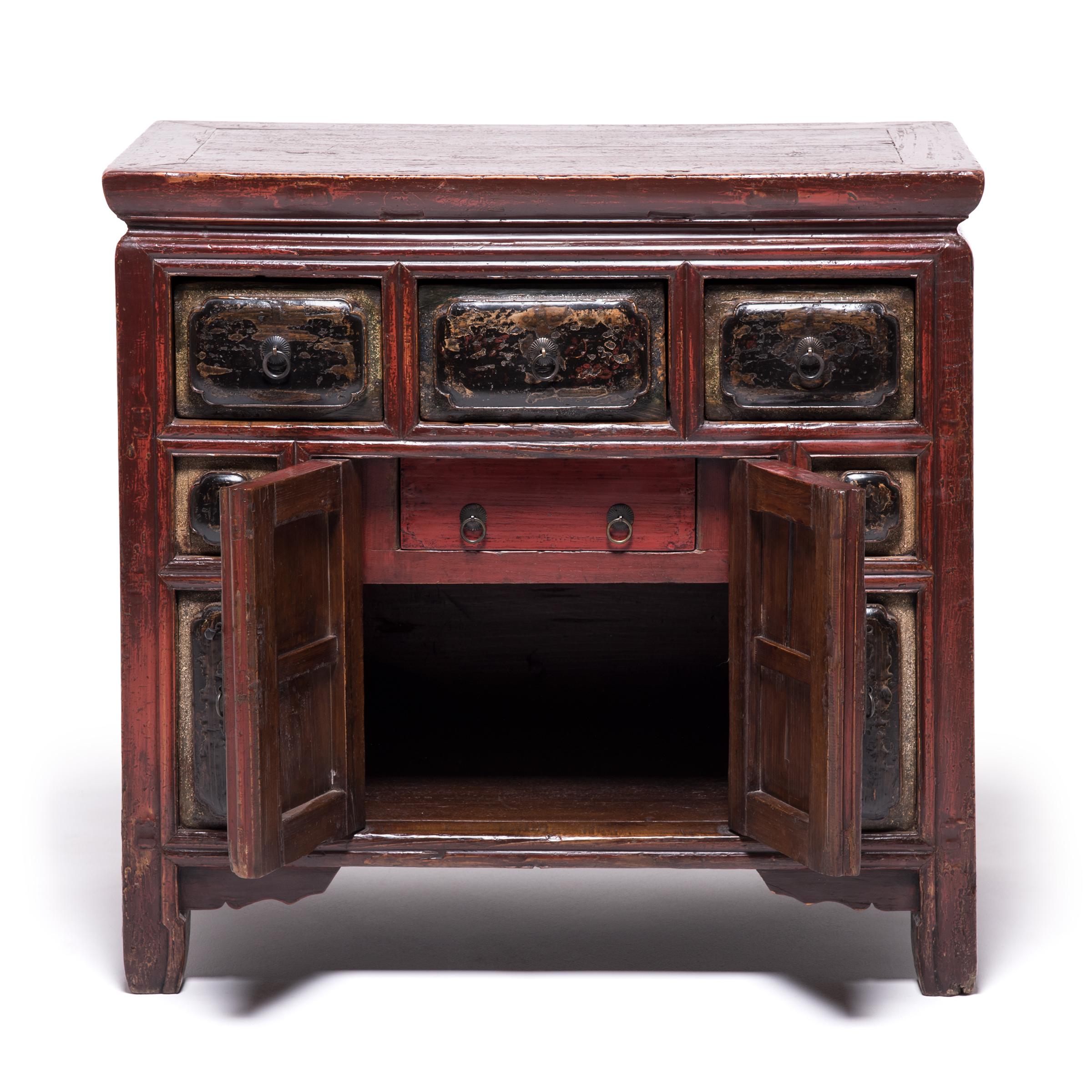 Carpenters in China's Fujian province during the late Qing dynasty frequently experimented with new carving techniques and ornate finishes. A collection of varying techniques, this provincial red-lacquered storage chest features cushion carved