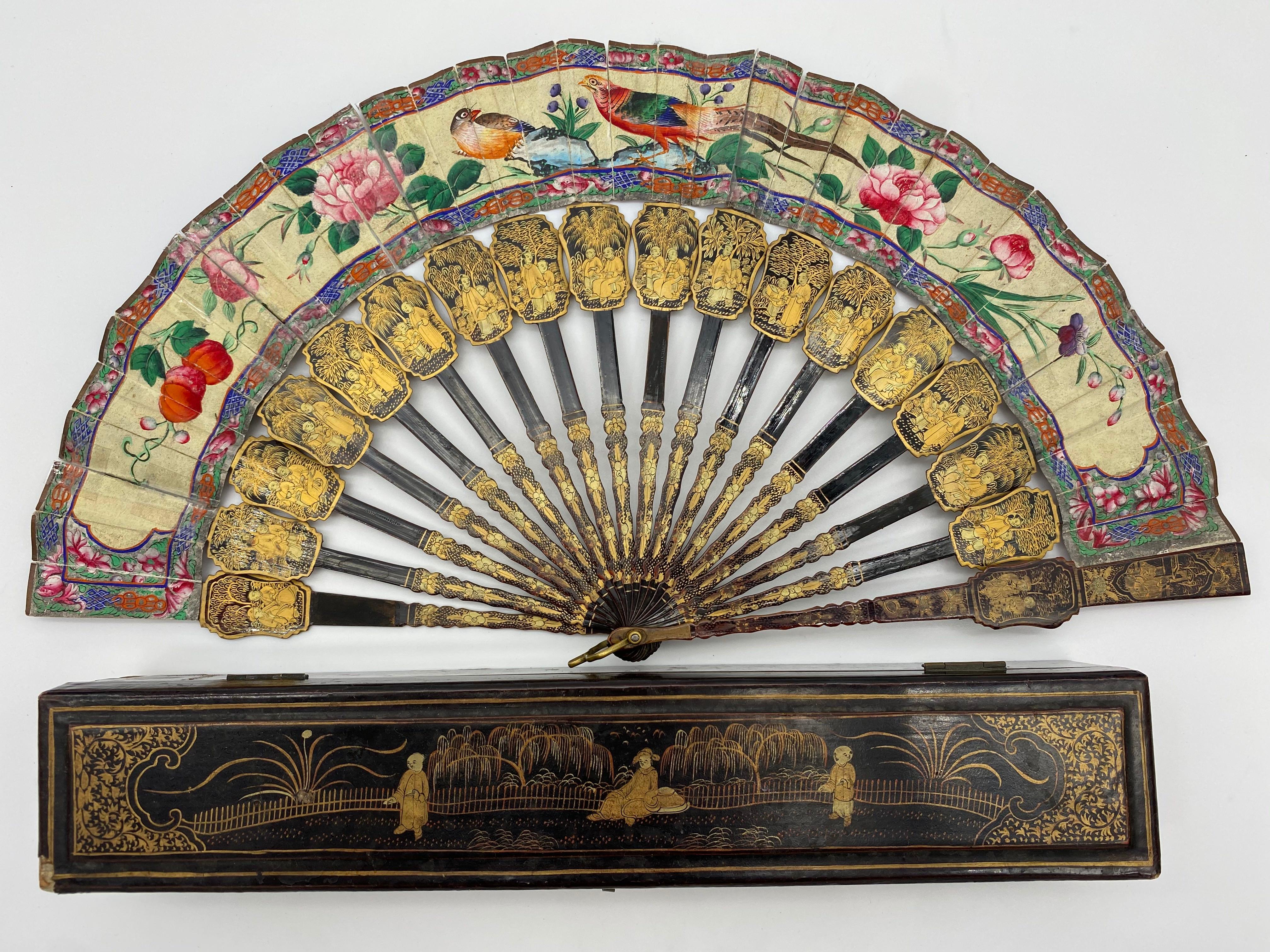 Antique 19th century hand painted Chinese fan with mother of pearl faces, Qing dynasty, the fan features black and gold lacquered handled a colorful screen with a figural, hand painted, scene with antique lacquer fan box. Fan is 16inch x 8 x 1.5,