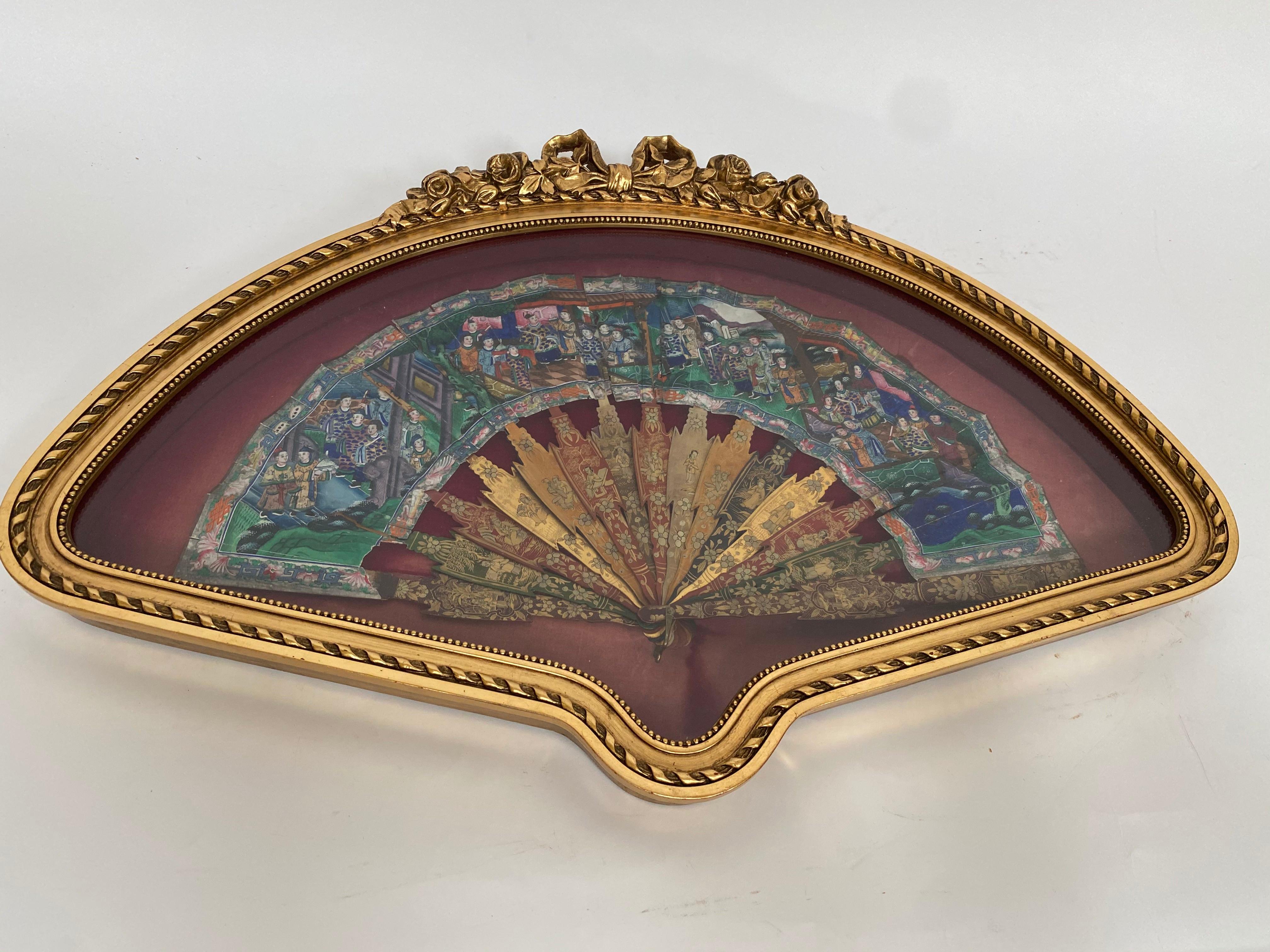 Antique 19th century hand painted Chinese fan with mother of pearl faces, Qing dynasty, the fan features black and gold lacquered handled a colorful screen with a figural, hand painted, scene in shades of blue, green, purple and brown and red. With