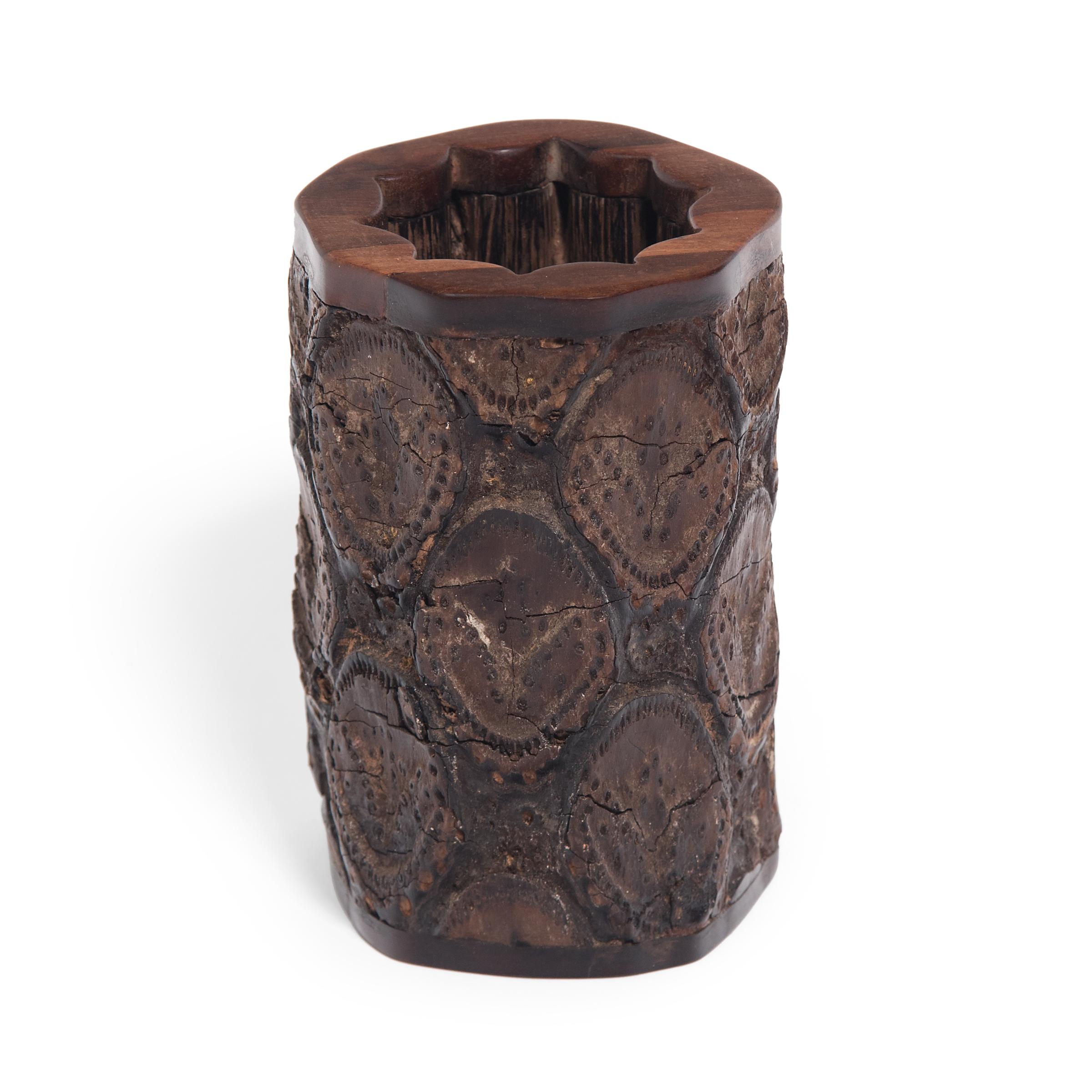 A brush pot, such as this one made in Hainan province, may once have sat on the desk of a learned scholar next to his brushes, inkpot, and ink stone. Made of rustic, gnarled wood, the brush pot would have brought to mind ancient trees depicted in