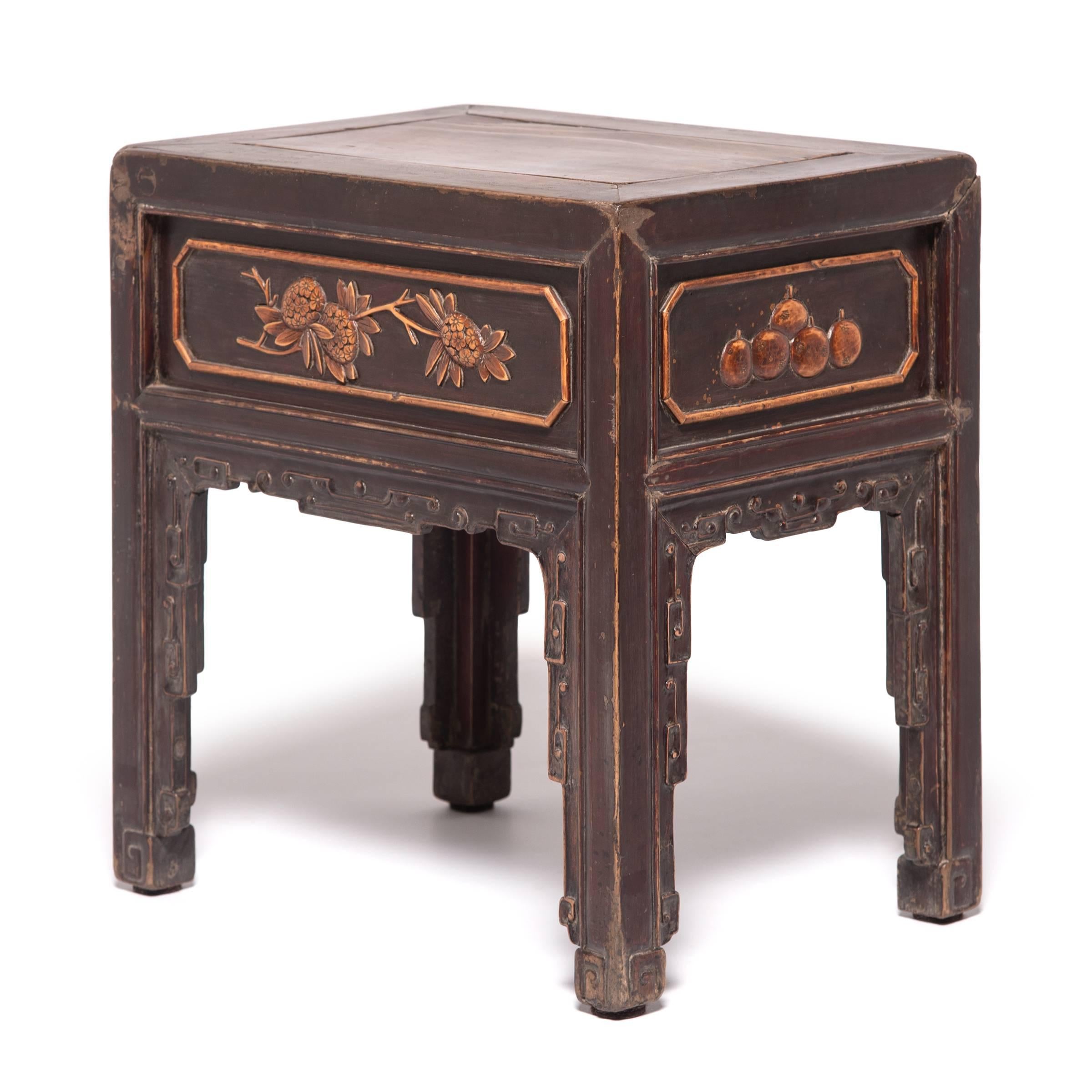 Created by a Qing dynasty artisan over 150 years ago, this petite table with boxwood inlay of auspicious fruit and floral arrangements was likely used as a display stand for a figure or ceramic vase. Appreciated for its smooth texture and bright