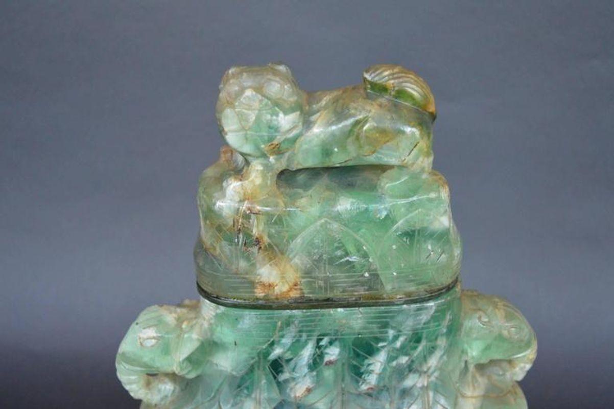 Chinese green hand-carved fluorite vase with a wood base. Made in the early 20th Century, c. 1910.
Dimensions:
18.5