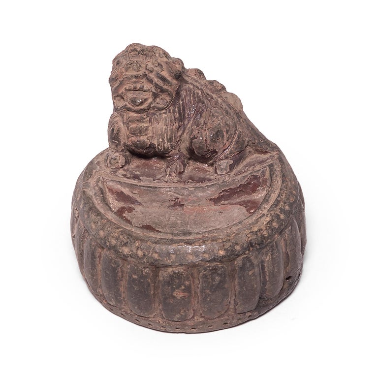 Hunkered down on his drum perch, a fu dog jealousy guards the pool where a calligrapher once prepared his ink. A symbol of protection, the lion-like beast bears the features of a shih-tzu, a dog originally bred to resemble this mythical canine.