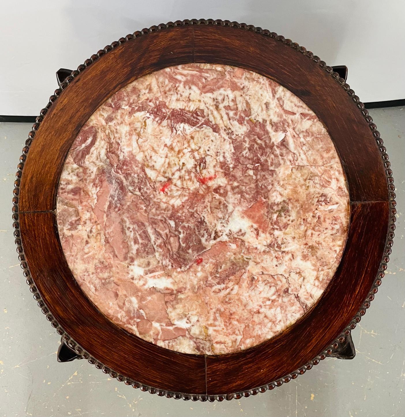 A stunning 19th century Chinese hand carved solid harwood end table or pot stand. The inset top of the table is graced with a pink gypsum marble top. The table features dazzling carving details of dragons on each corner as well as floral and