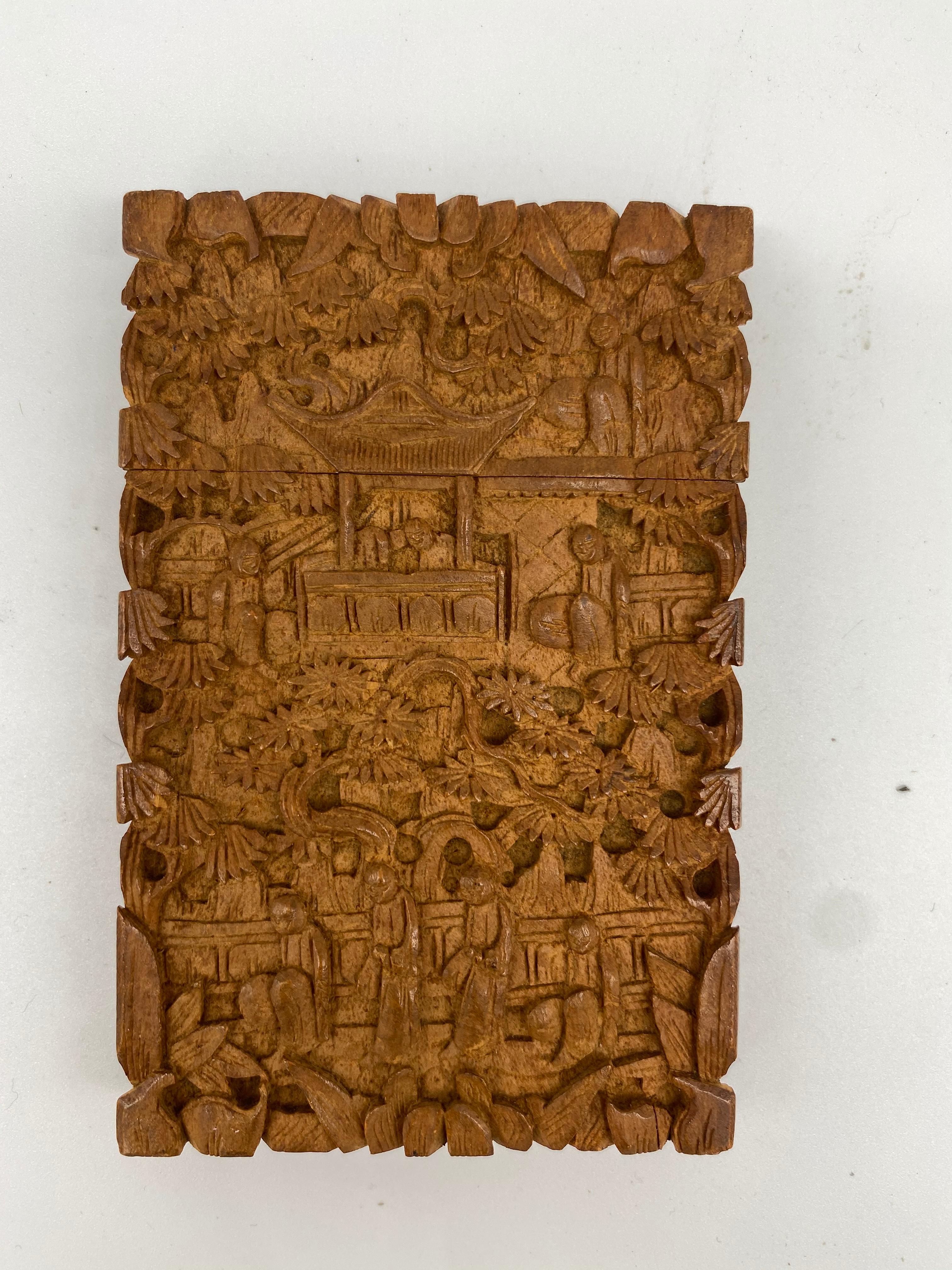19th century Chinese hand carved wood case with intricately designed carvings of people, villages, and foliage.