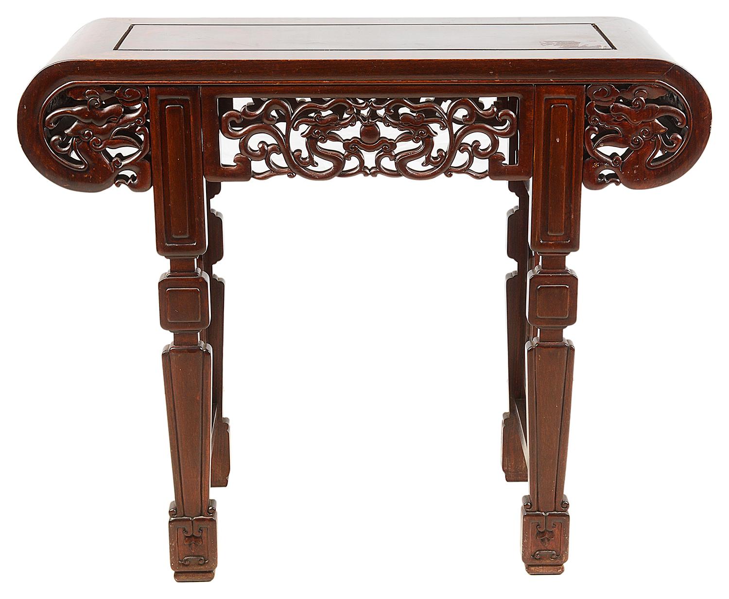 A good quality late 19th century Chinese hardwood alter table. Having carved scrolling decoration with mythical dragons to the frieze, raised on four tapering legs with raised panels within.