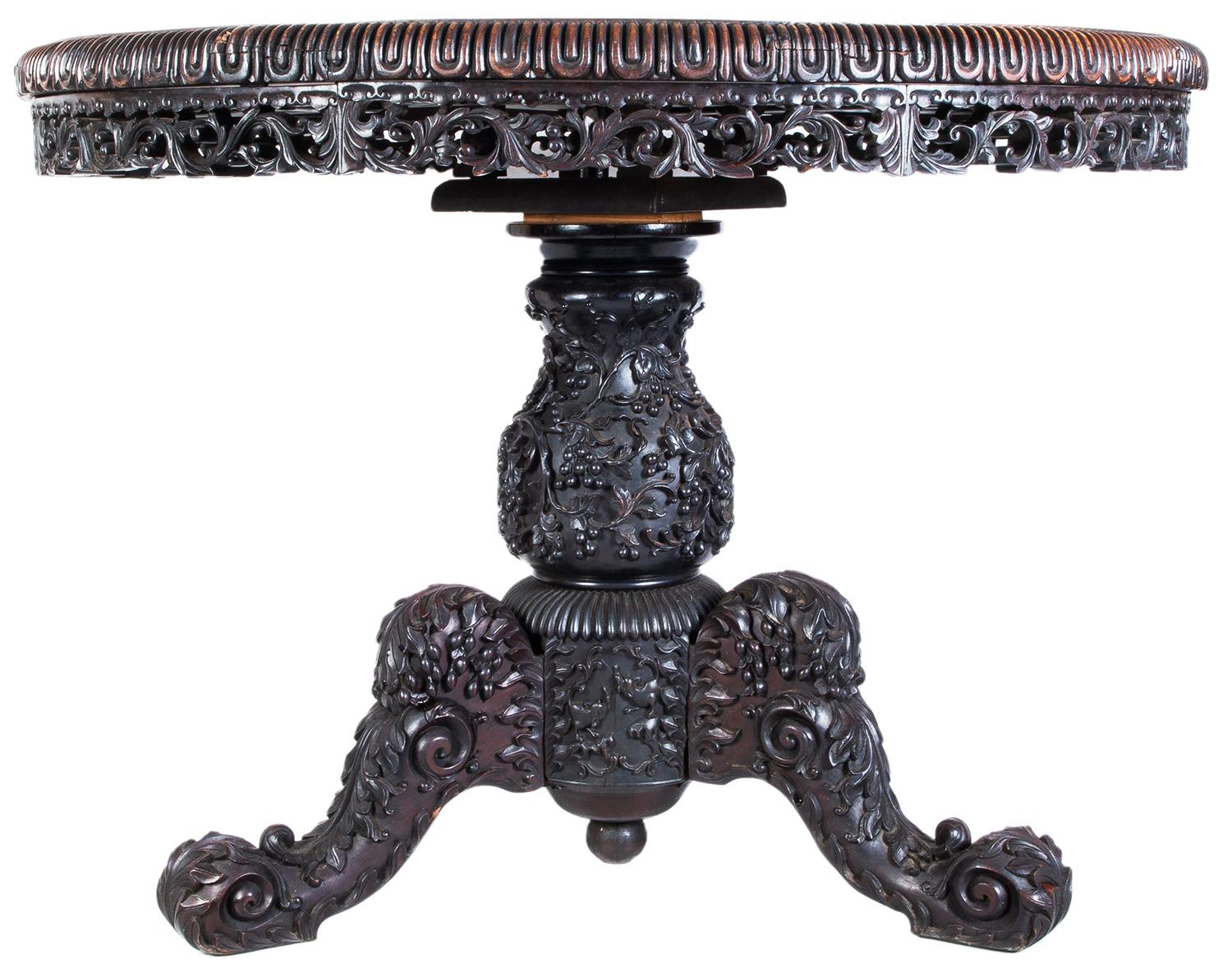 A very good quality 19th century Chinese hardwood centre table, having an inset rouge marble top, having a gadrooned edge, scrolling leaf and foliate decoration to the frieze, mounted on a bulbous pedestal with grape and vine leaf decoration, three