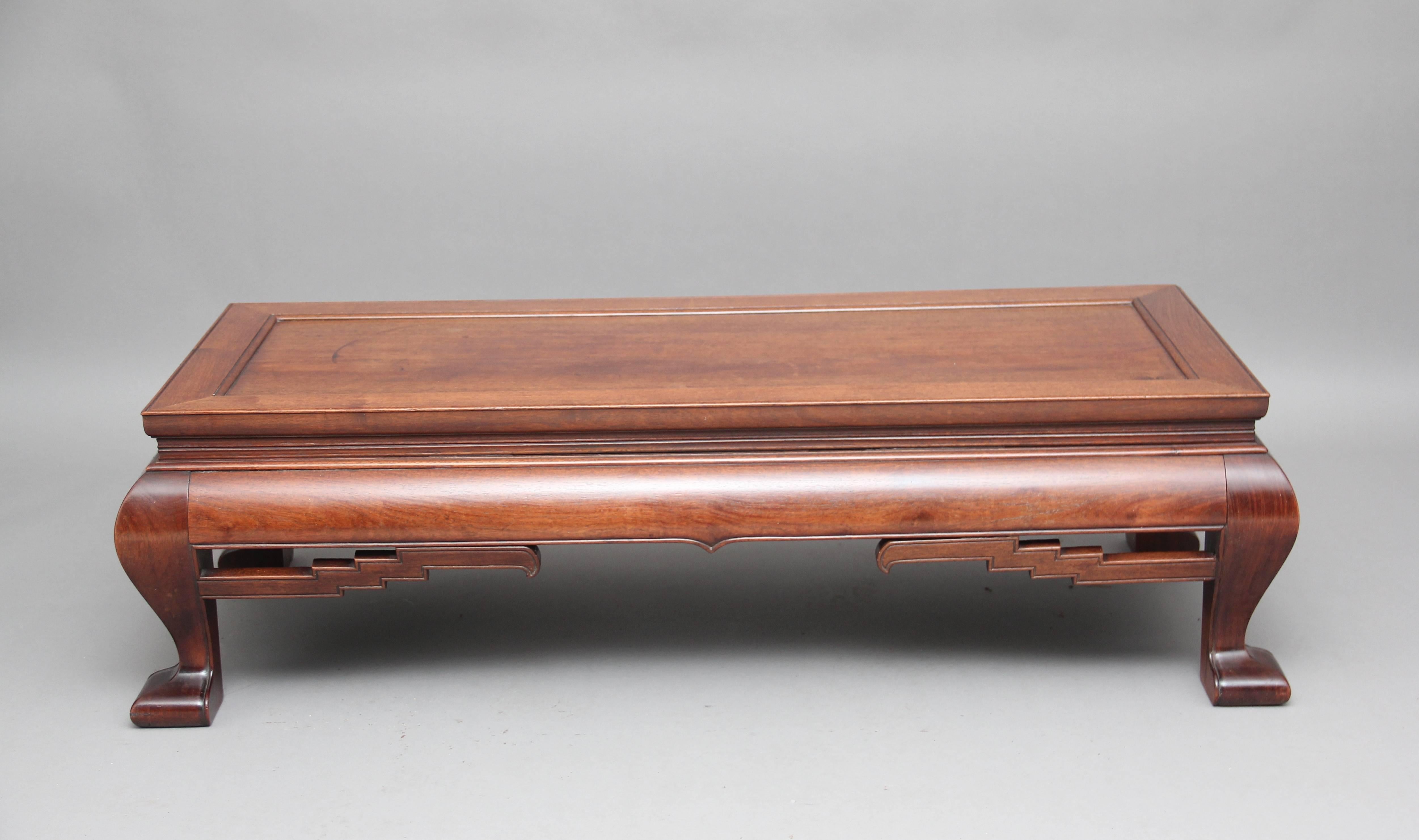 19th century Chinese hardwood coffee table, the stepped moulded rectangular top with a beaded edge frieze with carved fret decoration, supported on squat cabriole legs, circa 1890.