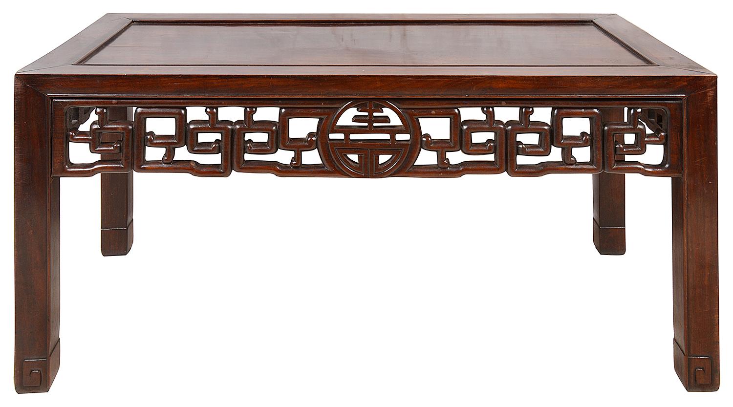 A good quality 19th century Chinese hardwood opium table, having a wonderful patina, an inset panel to the top, a carved fret work frieze and raise on square section legs.