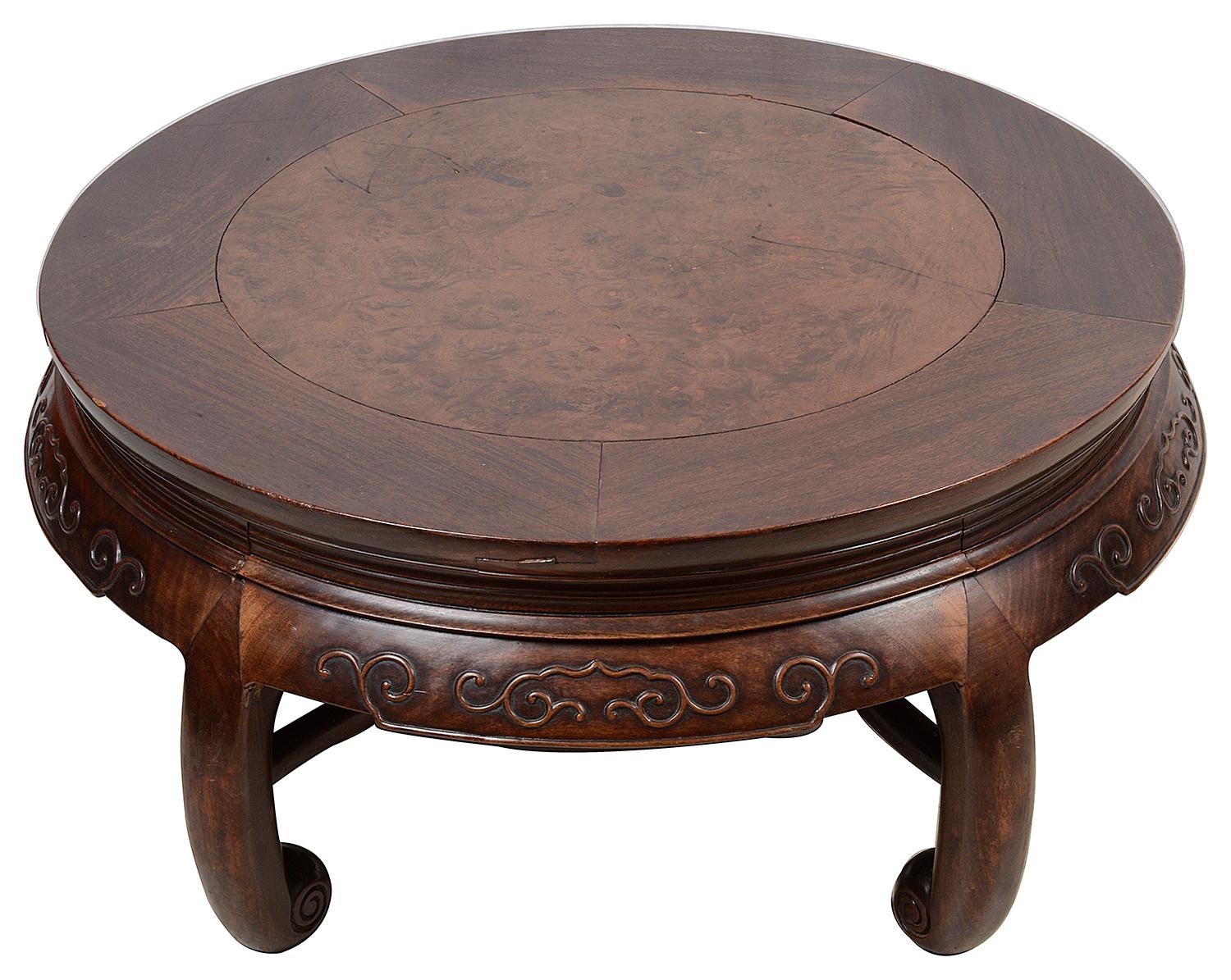 A very good quality 19th century Chinese carved hardwood circular Opium table, having in inset figured burr wood top, carved decoration to the frieze and raised on five scrolled supports, united by a stretcher.