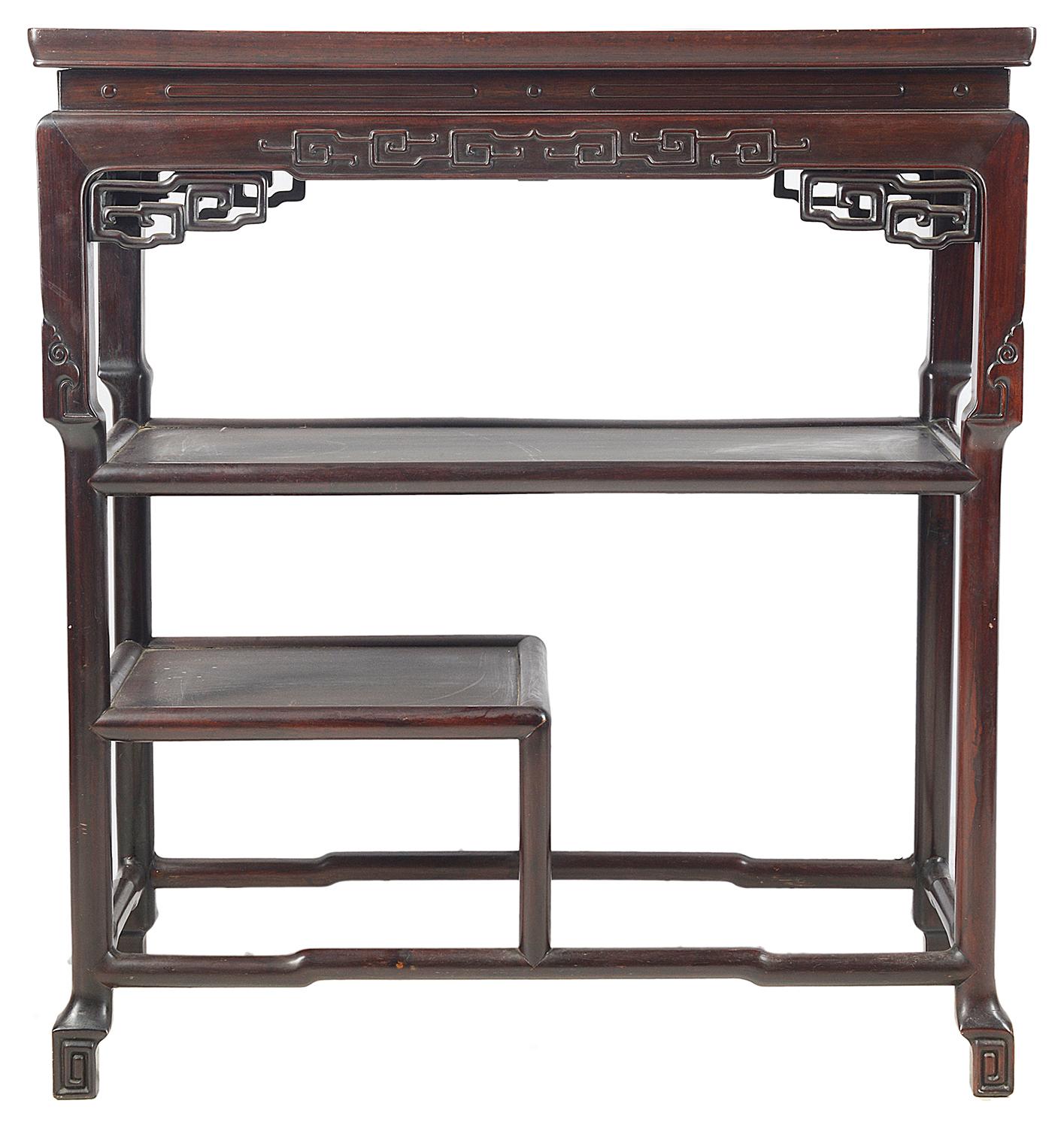A good quality 19th century Chinese hardwood three tier side table, having carved blind fret work to the frieze, carved fretwok brackets and two shelves beneath.