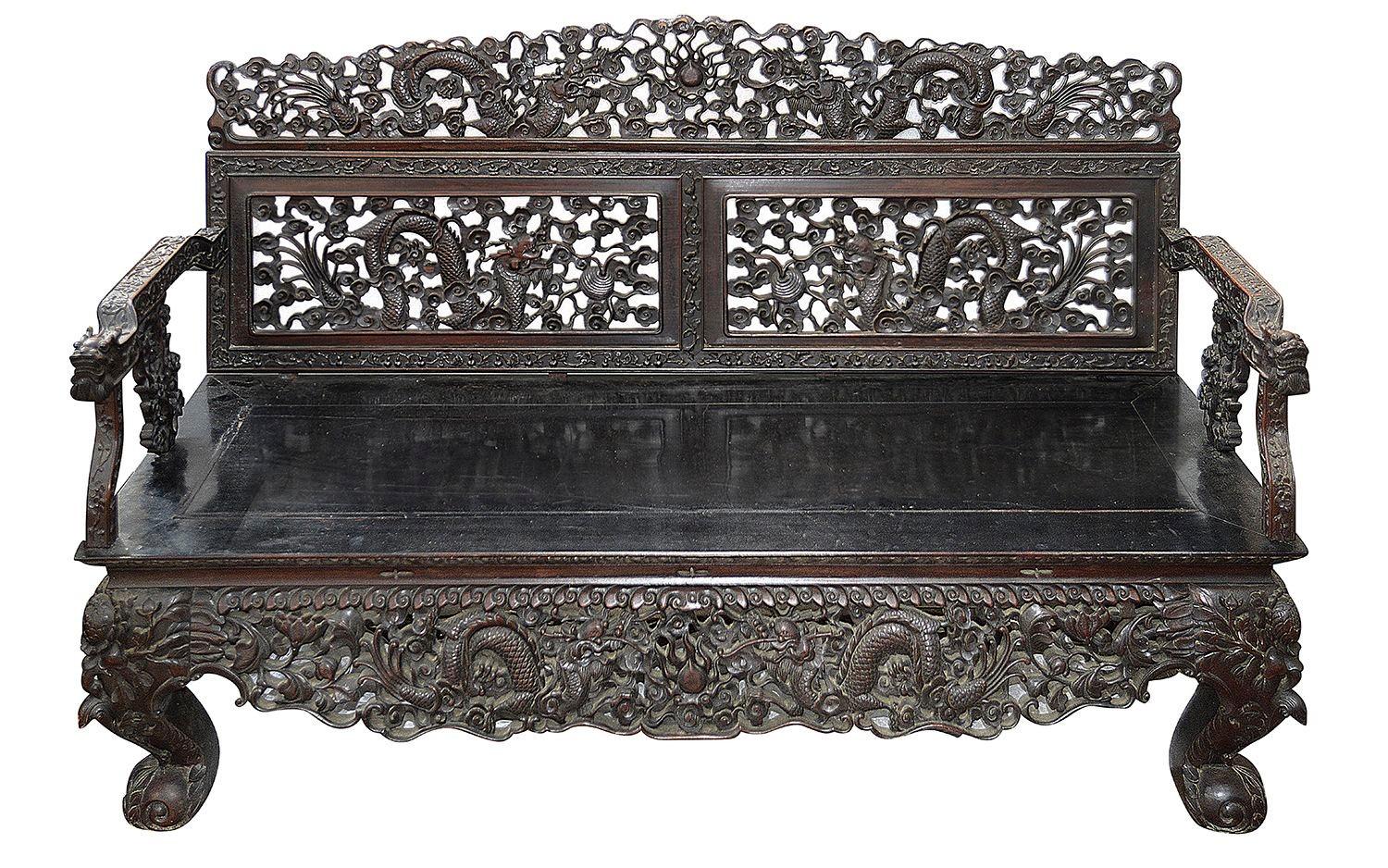A very good quality 19th Century Chinese hardwood three seater sofa, having wonderful classical hand carved and pierced scrolling foliate decoration with Dragons entwined. The seat with inset panels and raised on carved claw feet.
 
Batch 69.