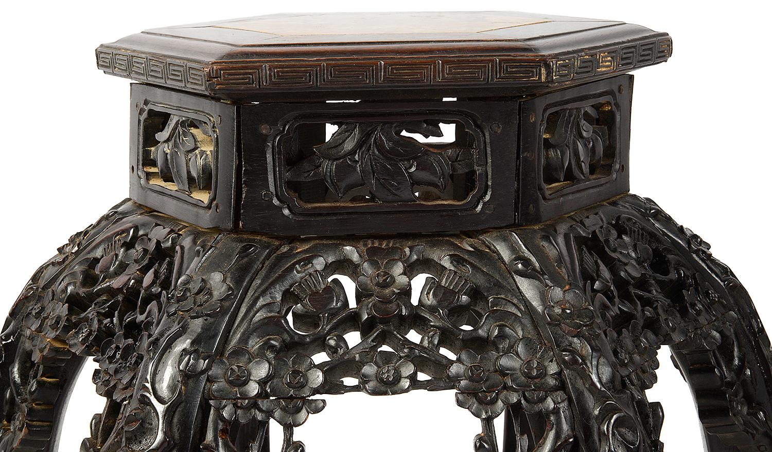 A good quality Chinese hardwood hexagona; inset marble-topped stand. Having well carved foliate and floral carving to the frieze, raised on six ornately carved legs, united by a carved under tier.