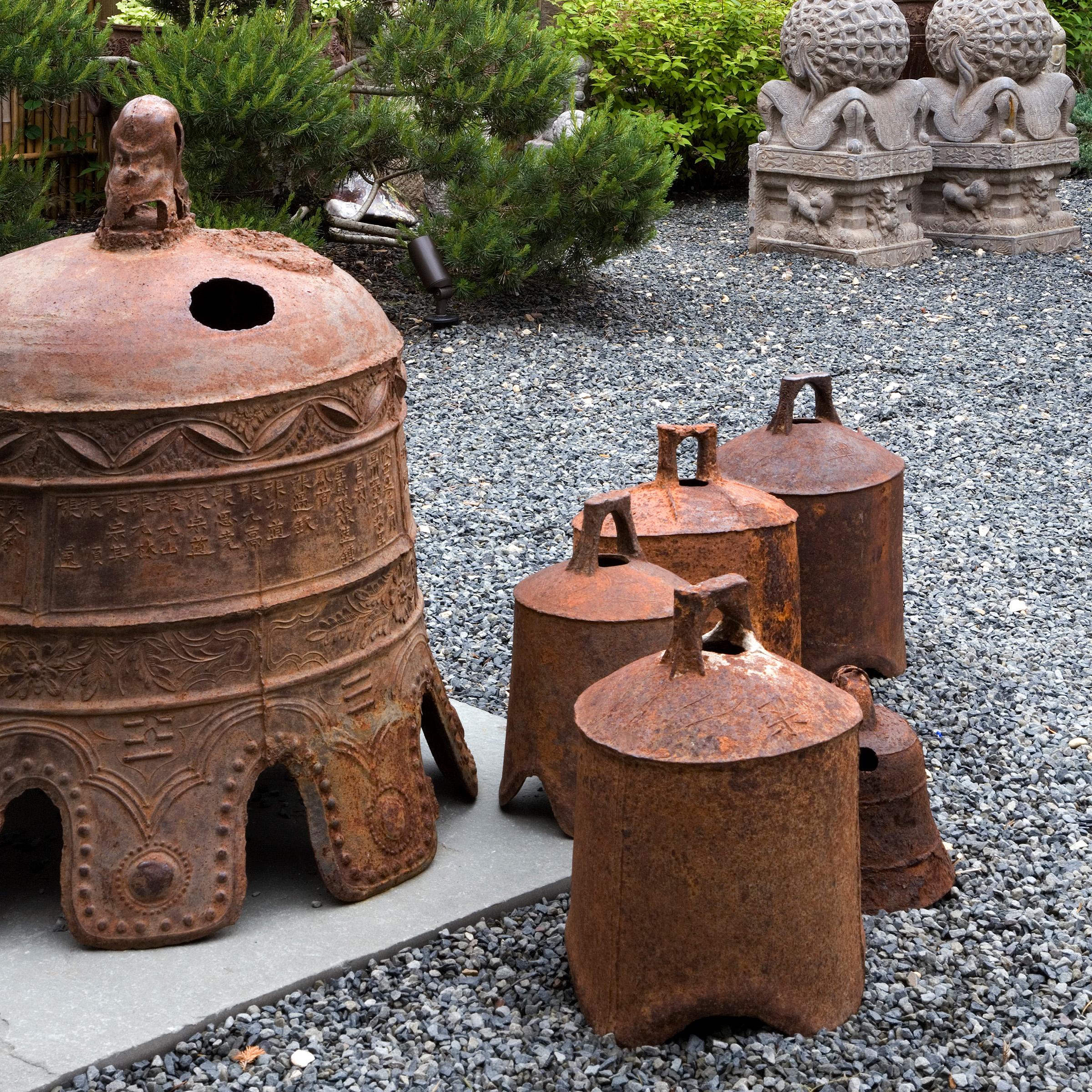 This rustic, 19th-century iron bell once pealed in celebration or gave notice of important events in a town in northern China. Marked with holes to affix the clapper or insert a pole, the bell looks lovely lit from within by a flickering candle or