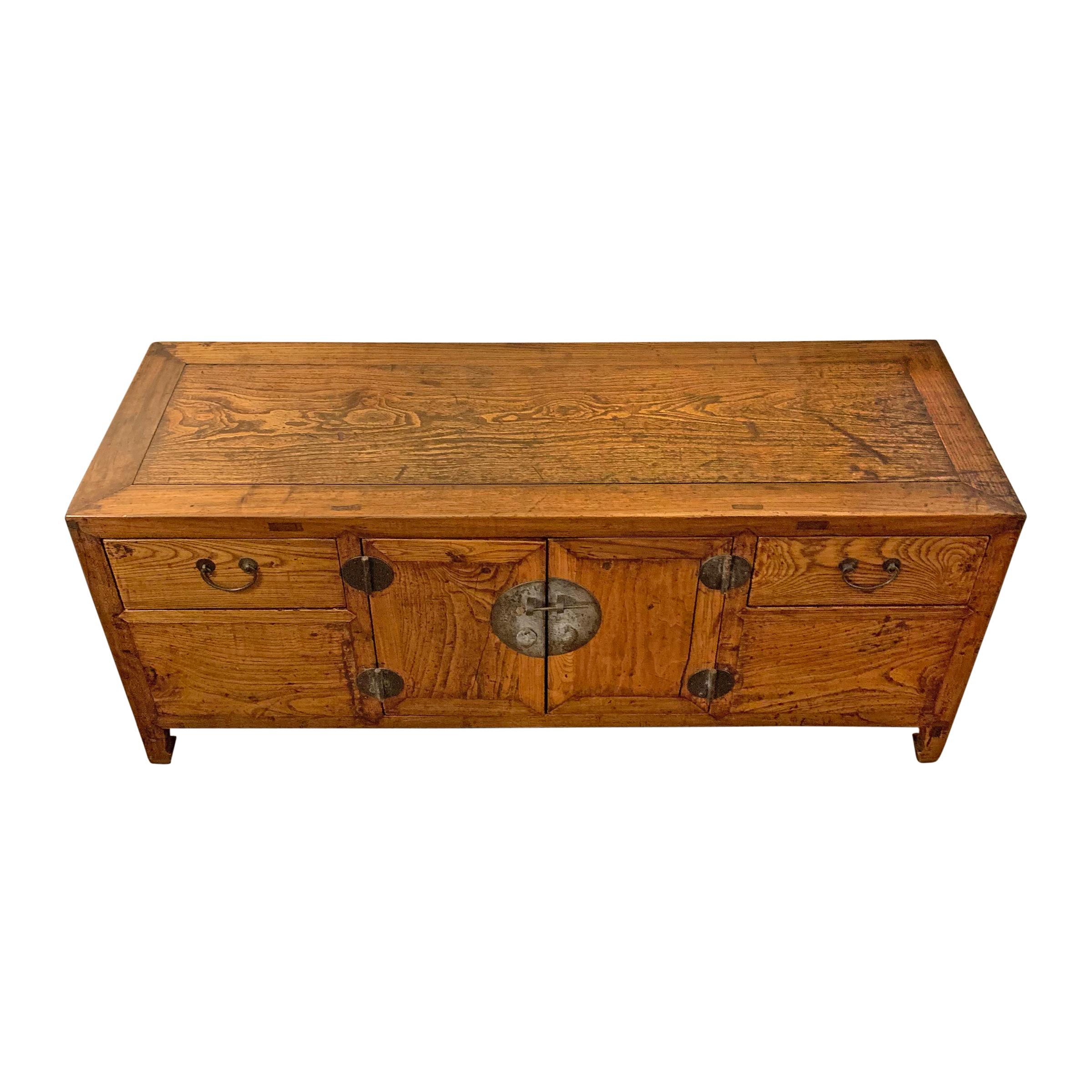 A wonderful late 19th century Chinese elm kang (low) chest with two doors and two drawers, and beautifully patinated bronze hardware.