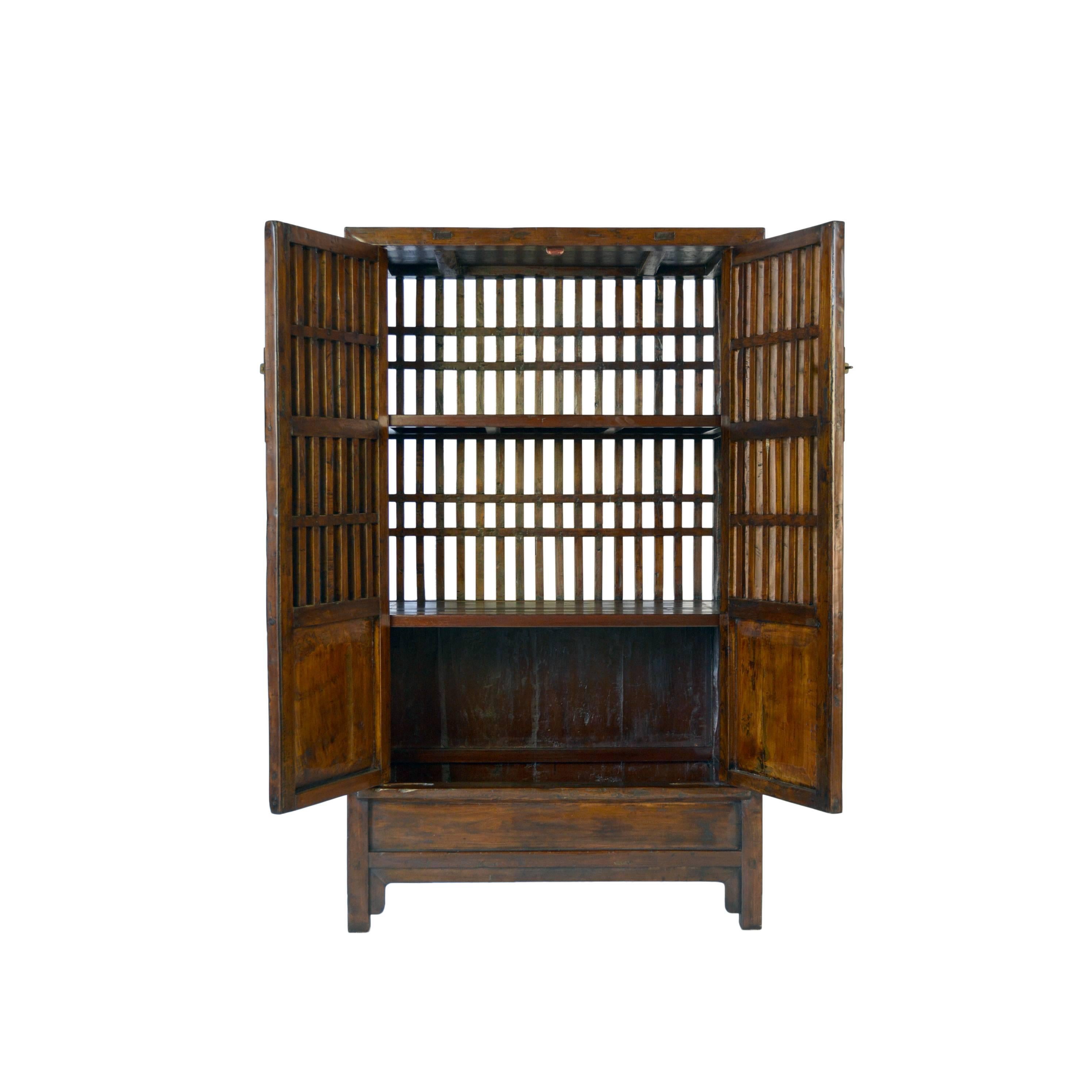 This cabinet from Zhejiang province, China was once used in a 19th century provincial kitchen to store fruits and vegetables. It has open lattice doors and an open lattice back, designed to keep its contents fresh. The cabinet's masterful mortise