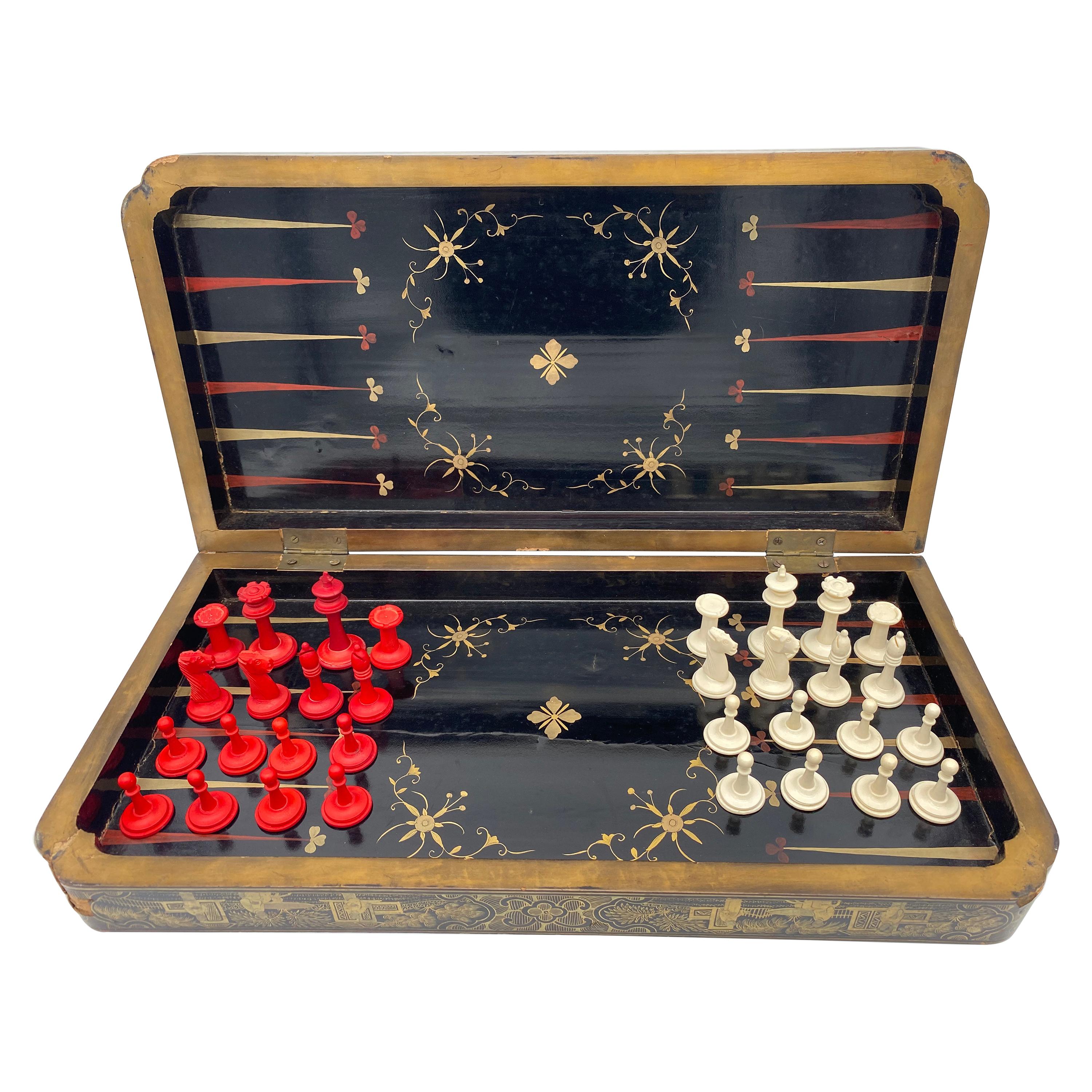 19th century Chinese export gilt decorated black lacquer gaming board. The game board painted with gilt seated figures in various poses on a black ground within a landscape vignette and floral border, opening to view a backgammon surface; together