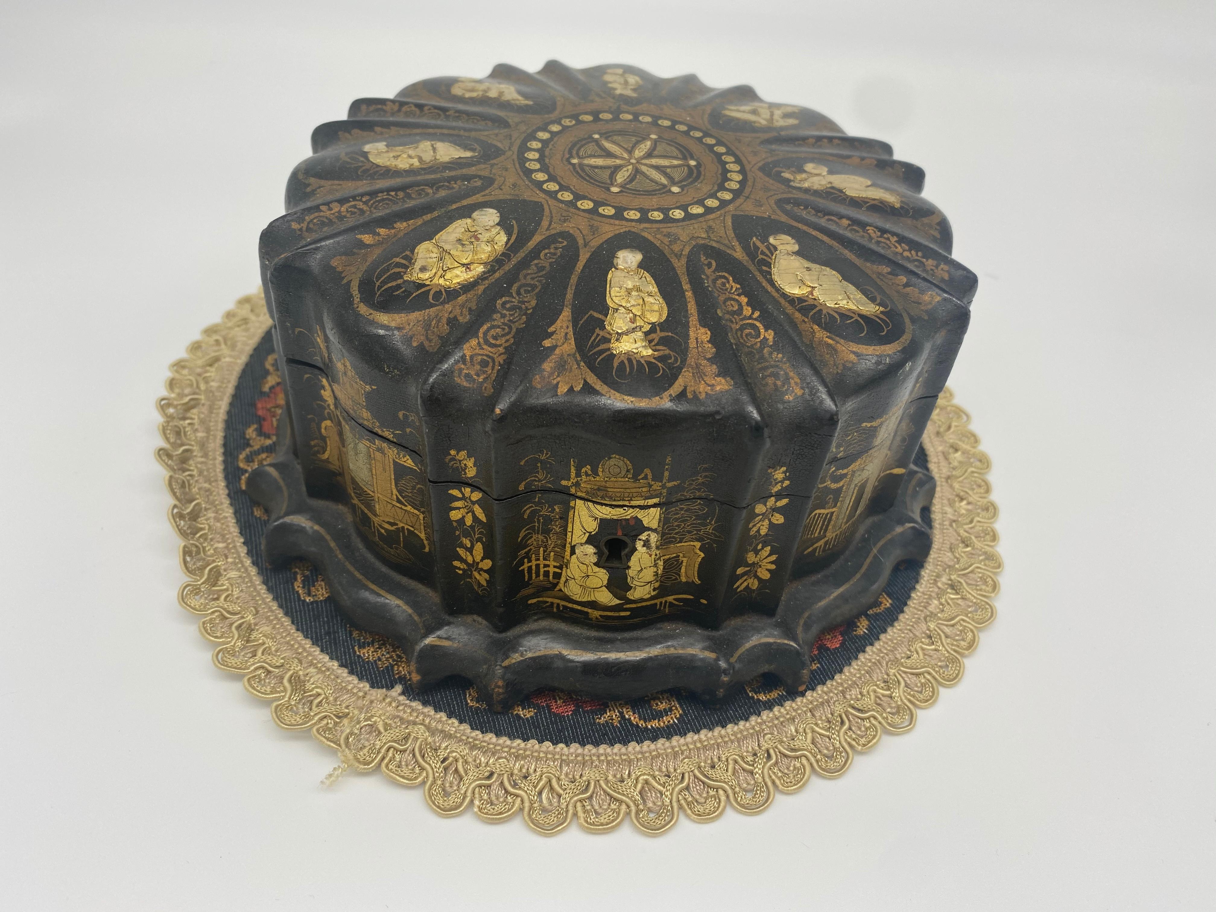 19th century Qing Dynasty Chinese lacquer jewelry box detailed with various genre scenes in gold detail. Pink silk lining, can be locked, does not include key. Very unique shape. Silk lining is deteriorated.