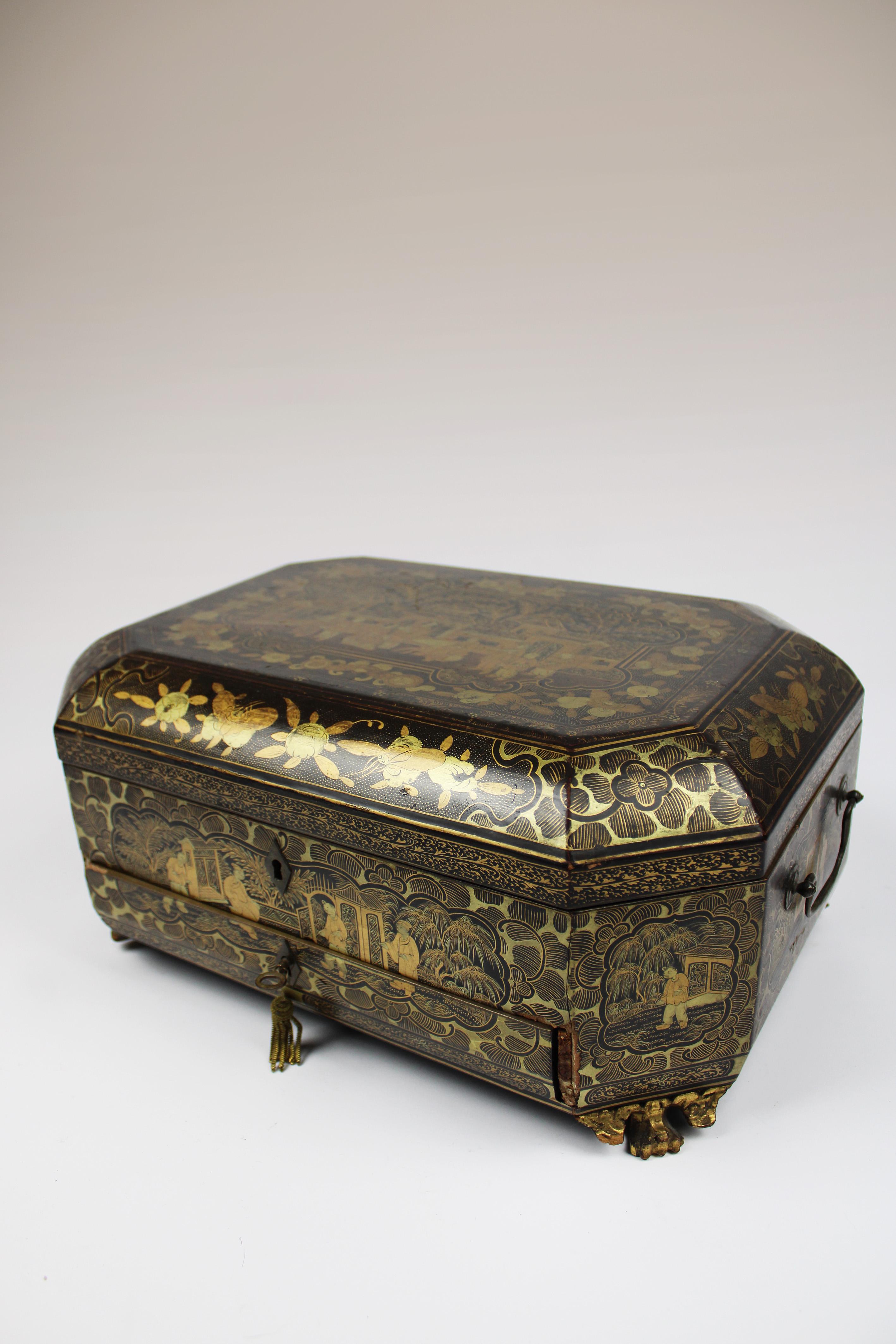 Immerse yourself in the timeless elegance of the early 19th century with this exquisite Chinese export lacquer sewing box. Crafted with meticulous attention to detail, this octagonal-shaped box stands gracefully on delicate feet, showcasing the