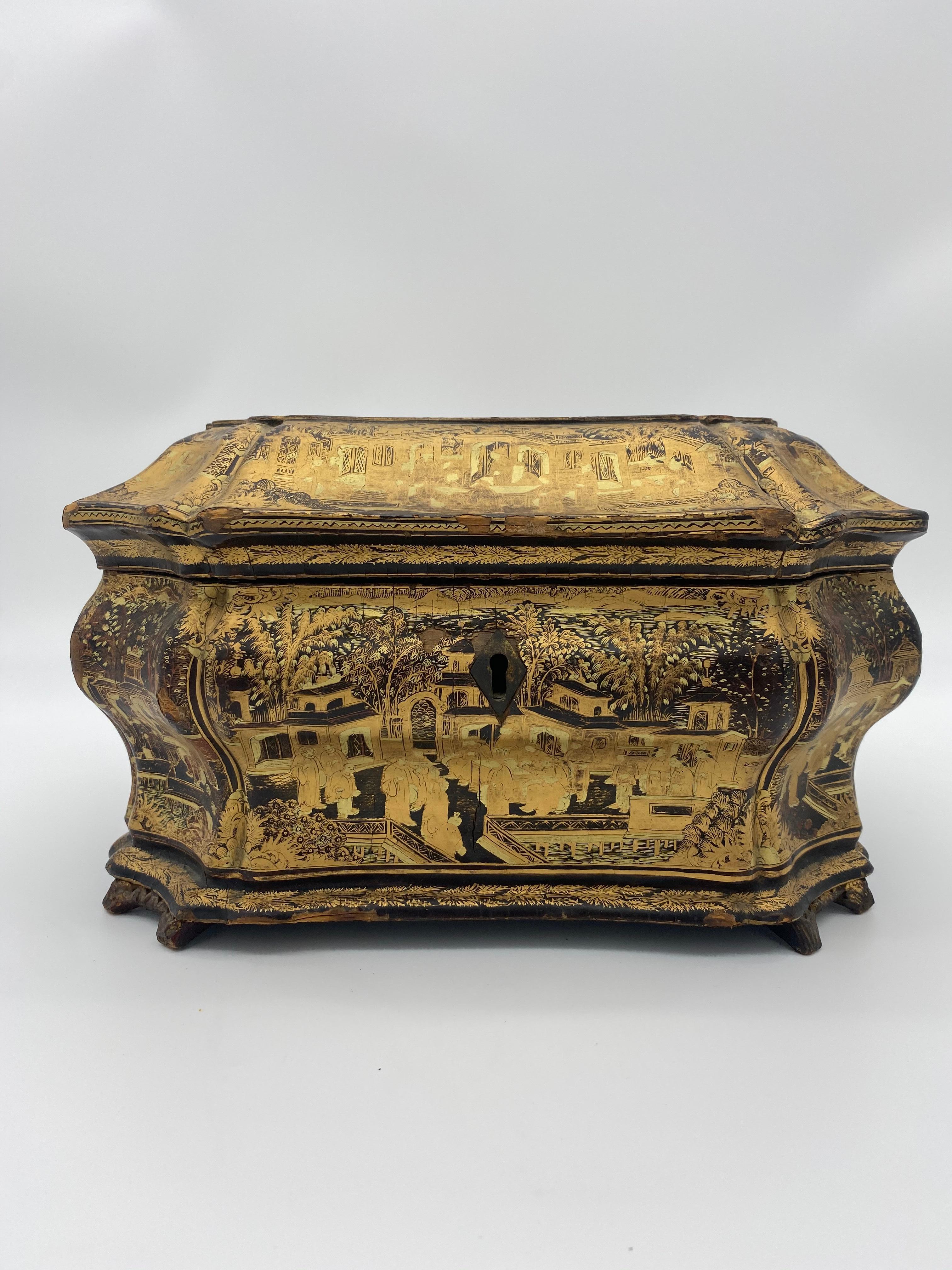 19th century Chinese lacquer tea caddy from the Qing dynasty. Beautiful golden and black color with intricate designs and images of the ancient Chinese.