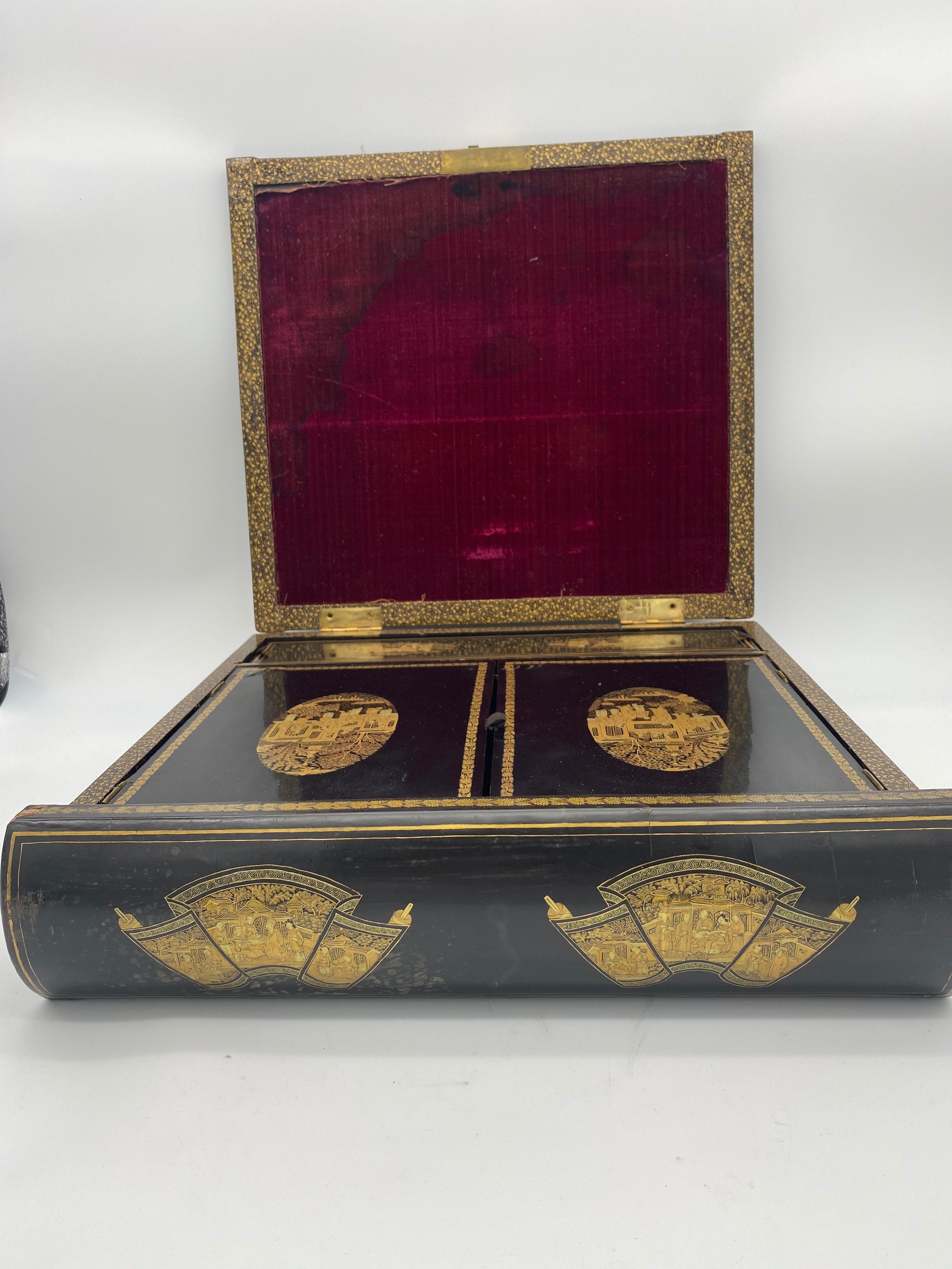 A truly beautiful and amazing piece. From the early 19th century derived from the Qing Dynasty in China, this lacquered writing box is decorated with the designs of two dragons frolicking with a pearl and 100 face. Some tears due to age, see