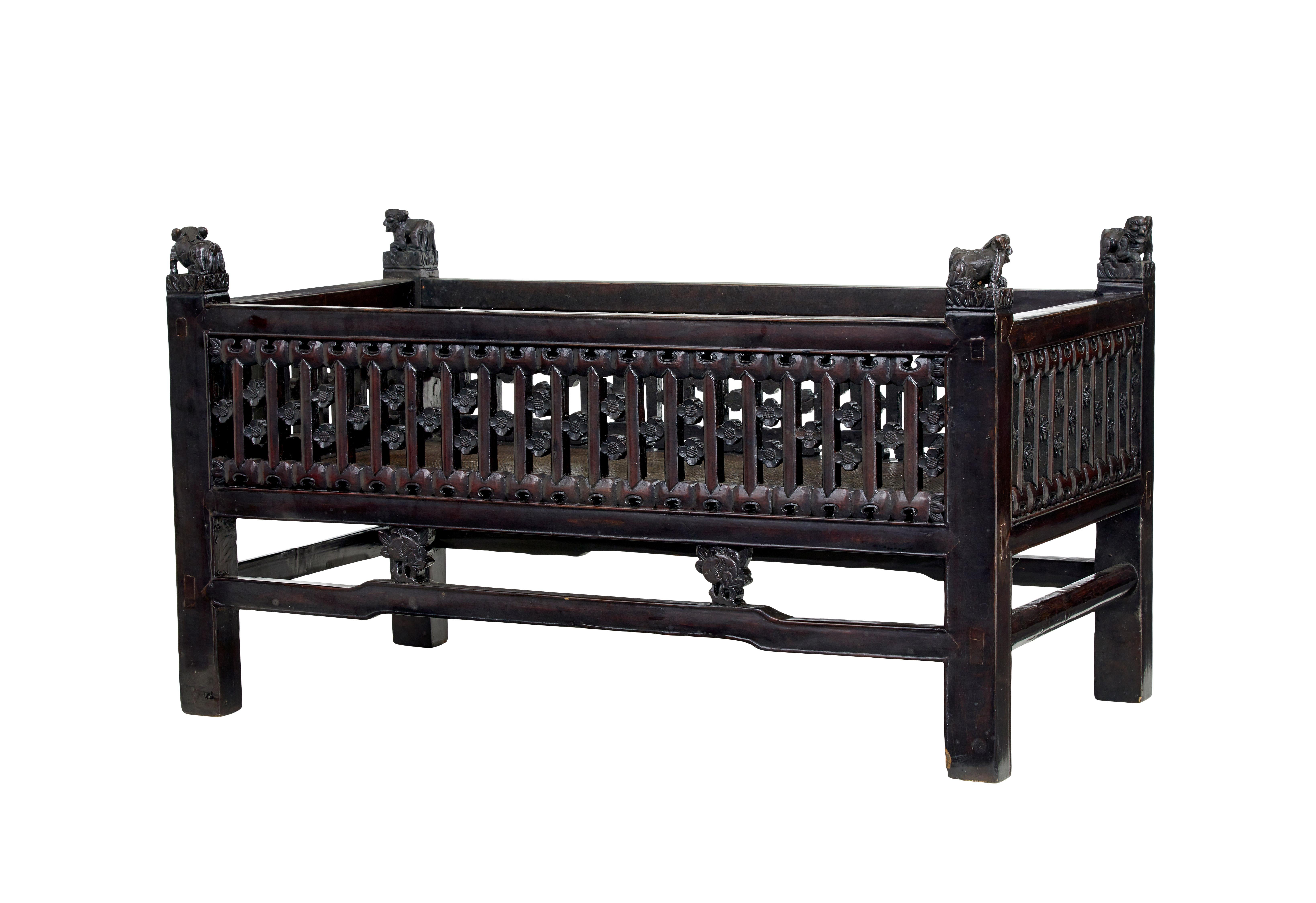 19th century Chinese carved hardwood bed circa 1890.

Chinese export which we believe may have been made as a childs bed. Carved pierced sides decorated with flowers.  Each corner with a carved dof of fo.  Hard rattan base.

In today's age it could
