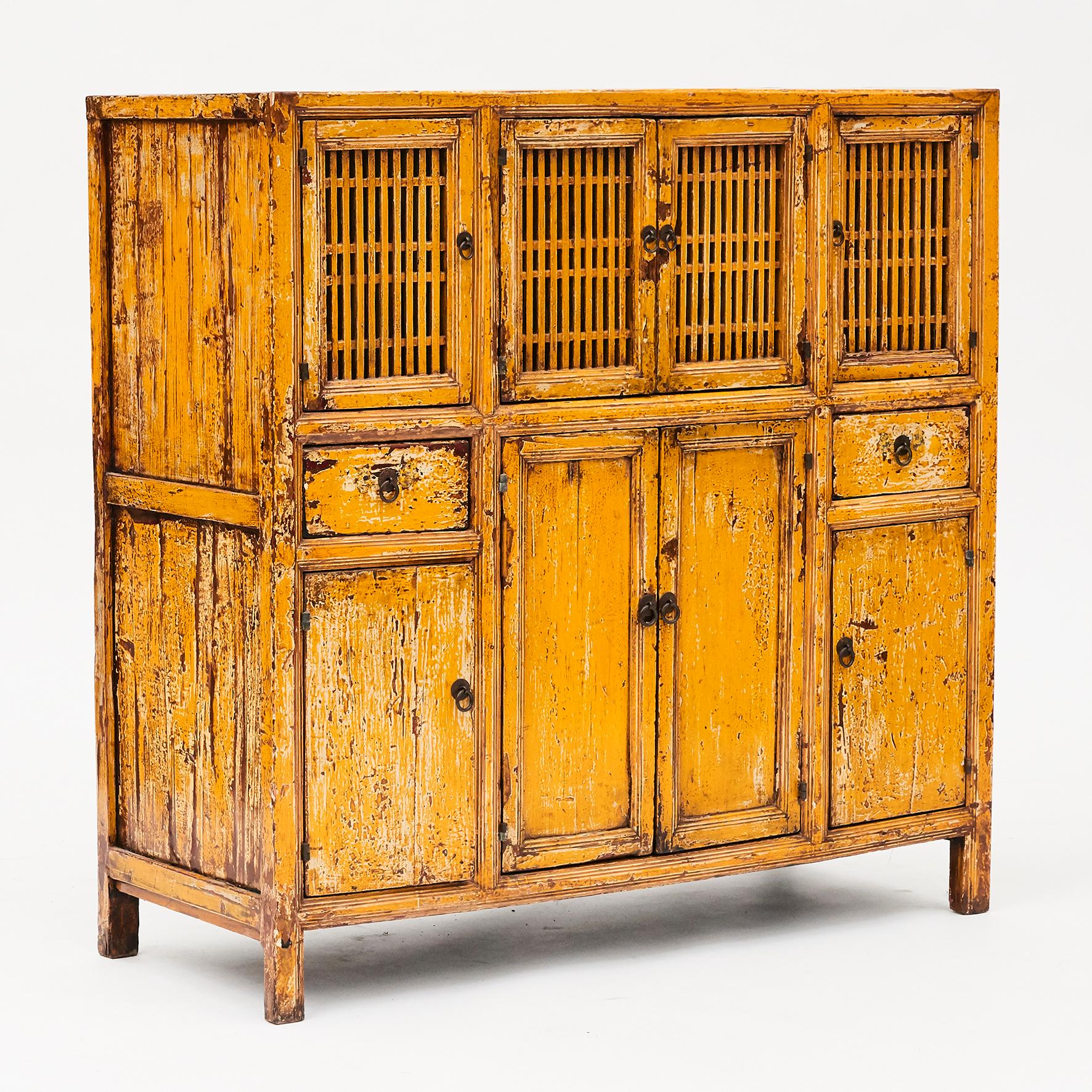 Lattice door cabinet from Shangdong, China and dates to the late 1800s.
Original condition and lacquer color with natural patina.
An extremely functional and pretty piece in a warm yellow color tone.

This type of cabinets was originally used to