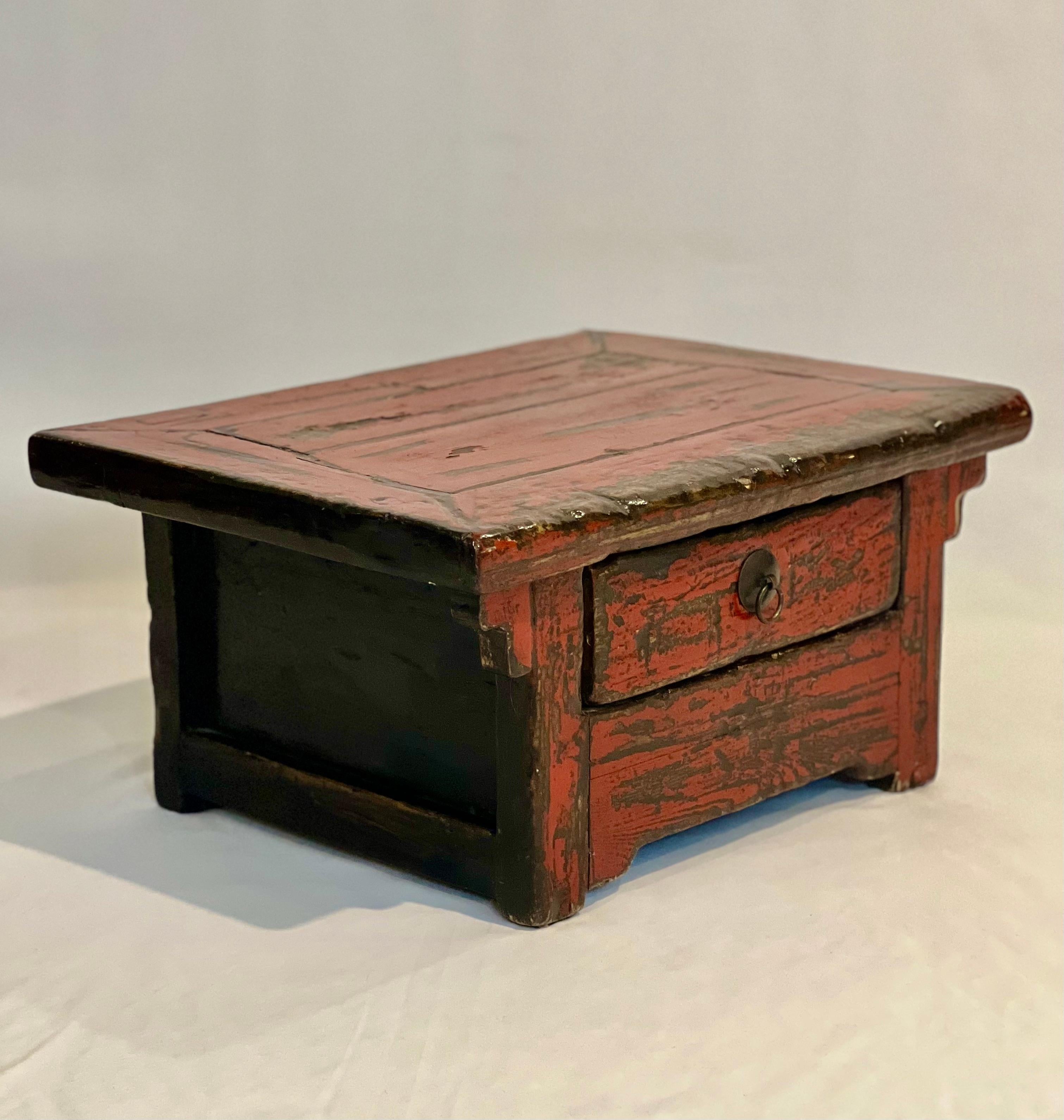 19th century Chinese Ming style red lacquered low tea table.

A finely crafted, petite elm table featuring a single drawer with a brass ring pull. In great vintage condition with fantastic aged patina in a richly hued red lacquer. Originally an